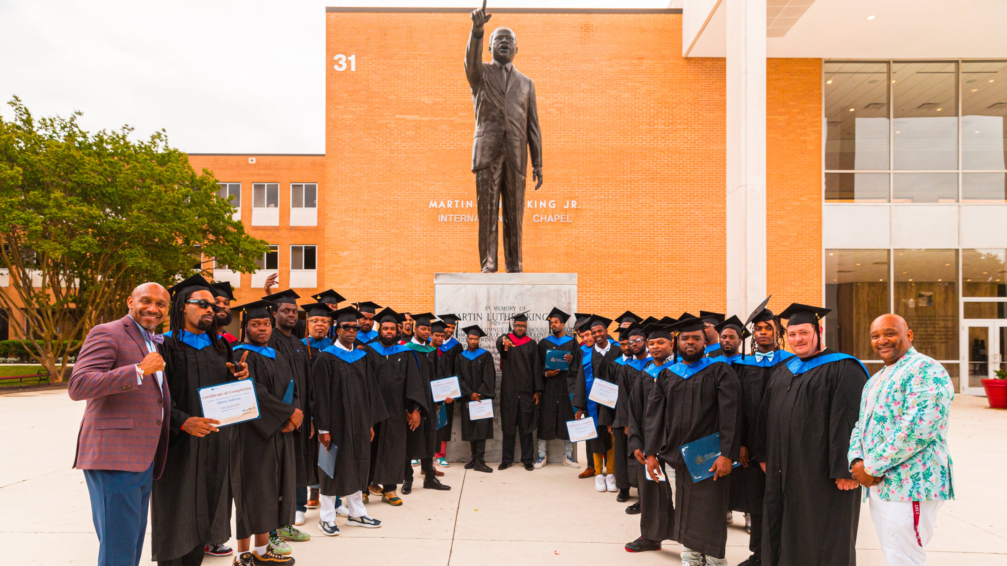 Graduates of the Fathers Incorporated program pose with diplomas at Morehouse College. (Courtesy of Fathers Incorporated)