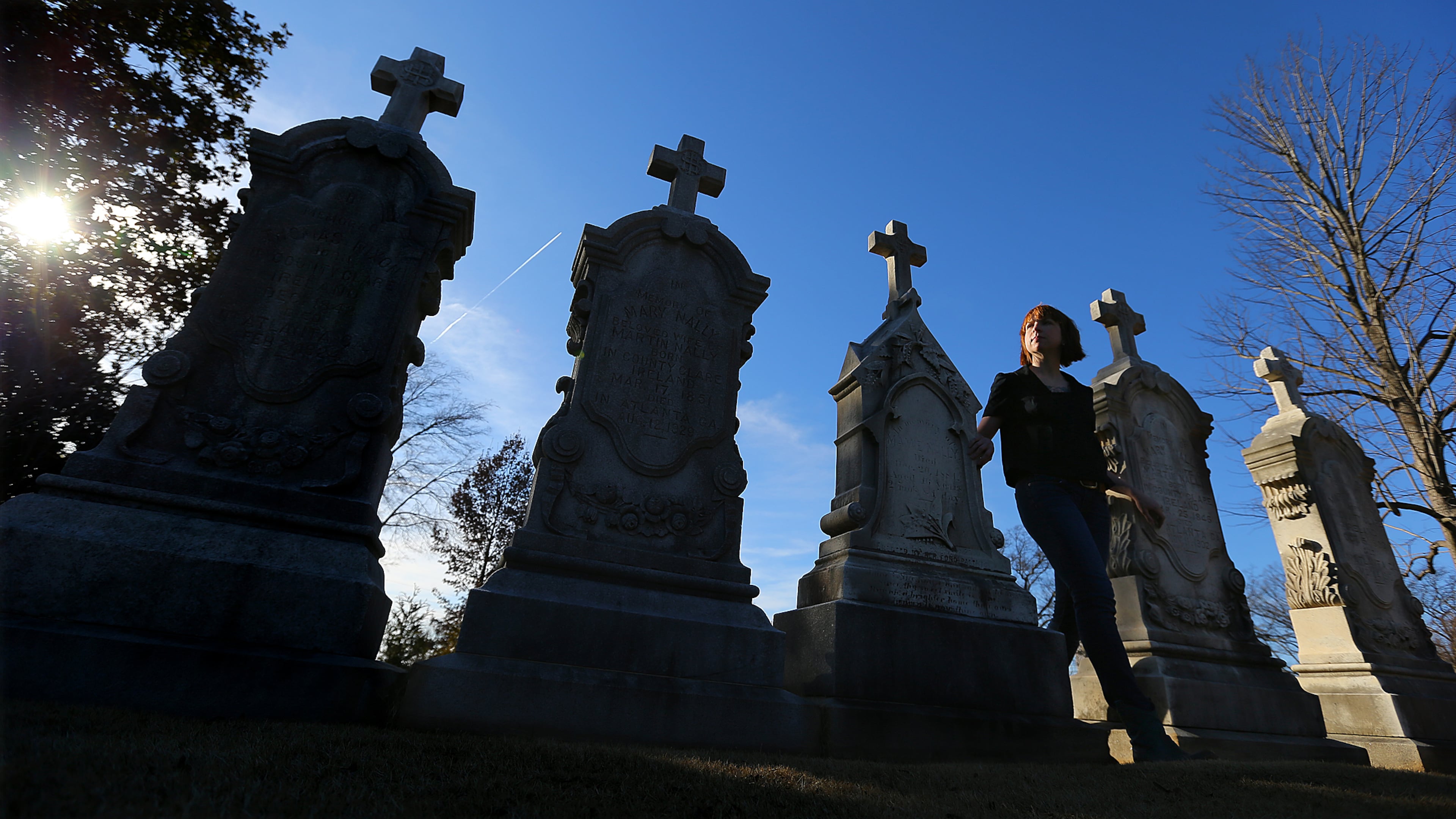 Sweeney makes her way between a series of Nally family graves at Oakland Cemetery.