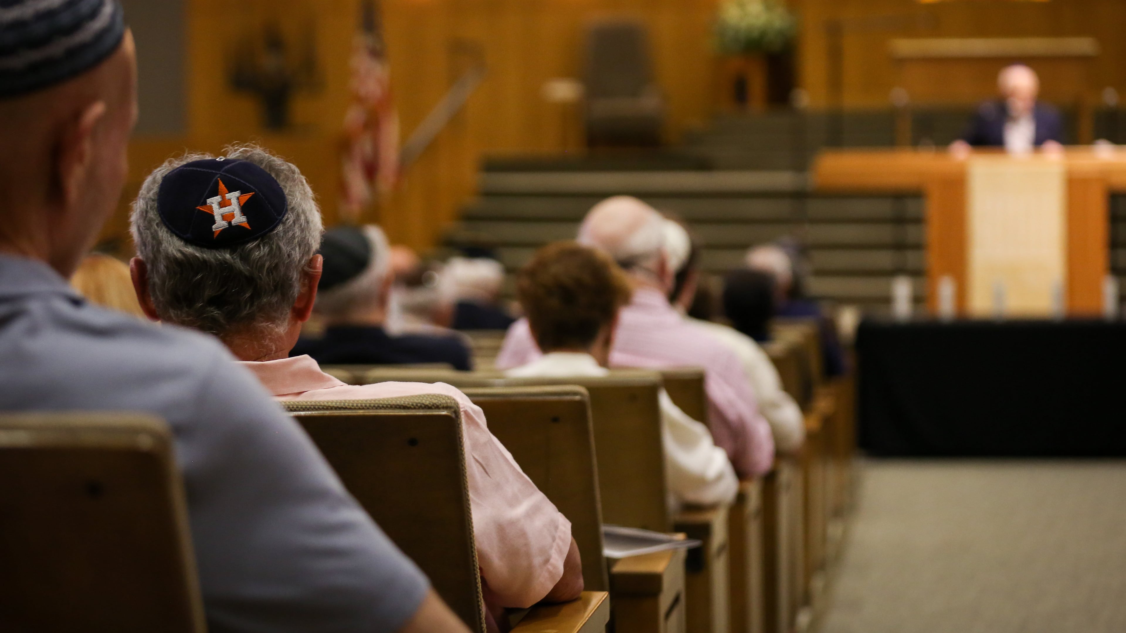 A man listens during a Yom HaShoah ceremony for Holocaust Remembrance Day, April 24, 2022, at Congregation Beth Israel in Houston. (Jon Shapley/Houston Chronicle via AP)