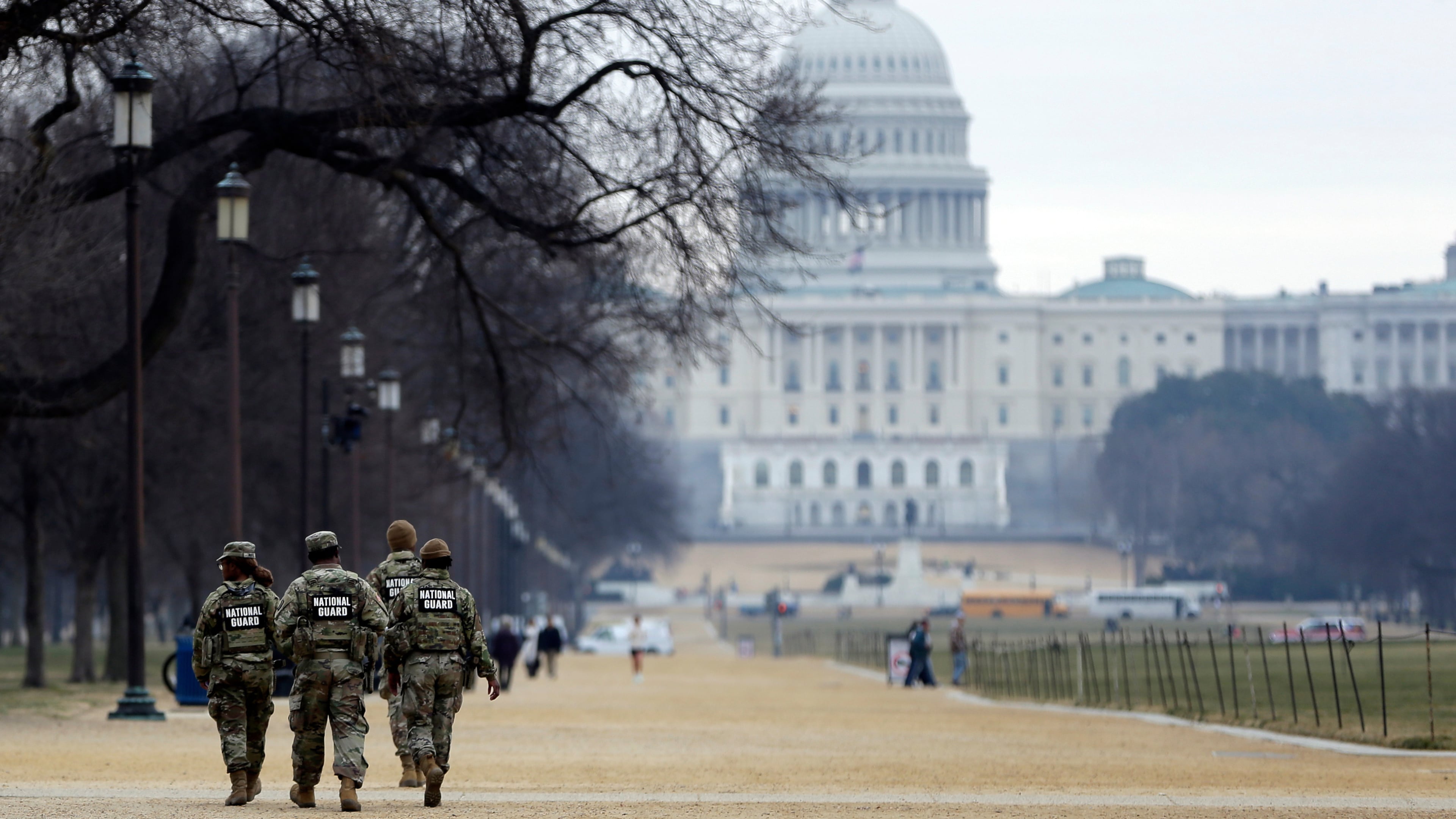 National Guard patrol the Washington Mall, with the U.S. Capitol in the background, Friday, Jan. 9, 2026, in Washington. (AP Photo/Rahmat Gul)