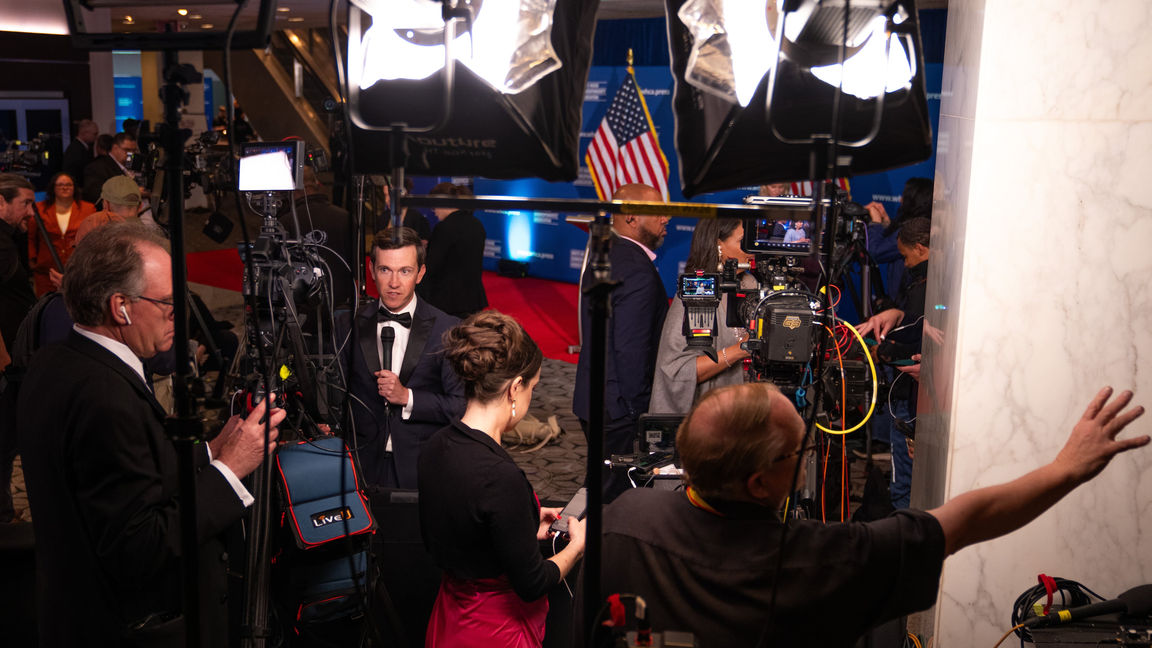 Journalists that were in attendance for the White House Correspondents Dinner work following a press briefing at the Washington Hilton following an incident that disrupted the event, Saturday, April 25, 2026, in Washington. (AP Photo/Allison Robbert)