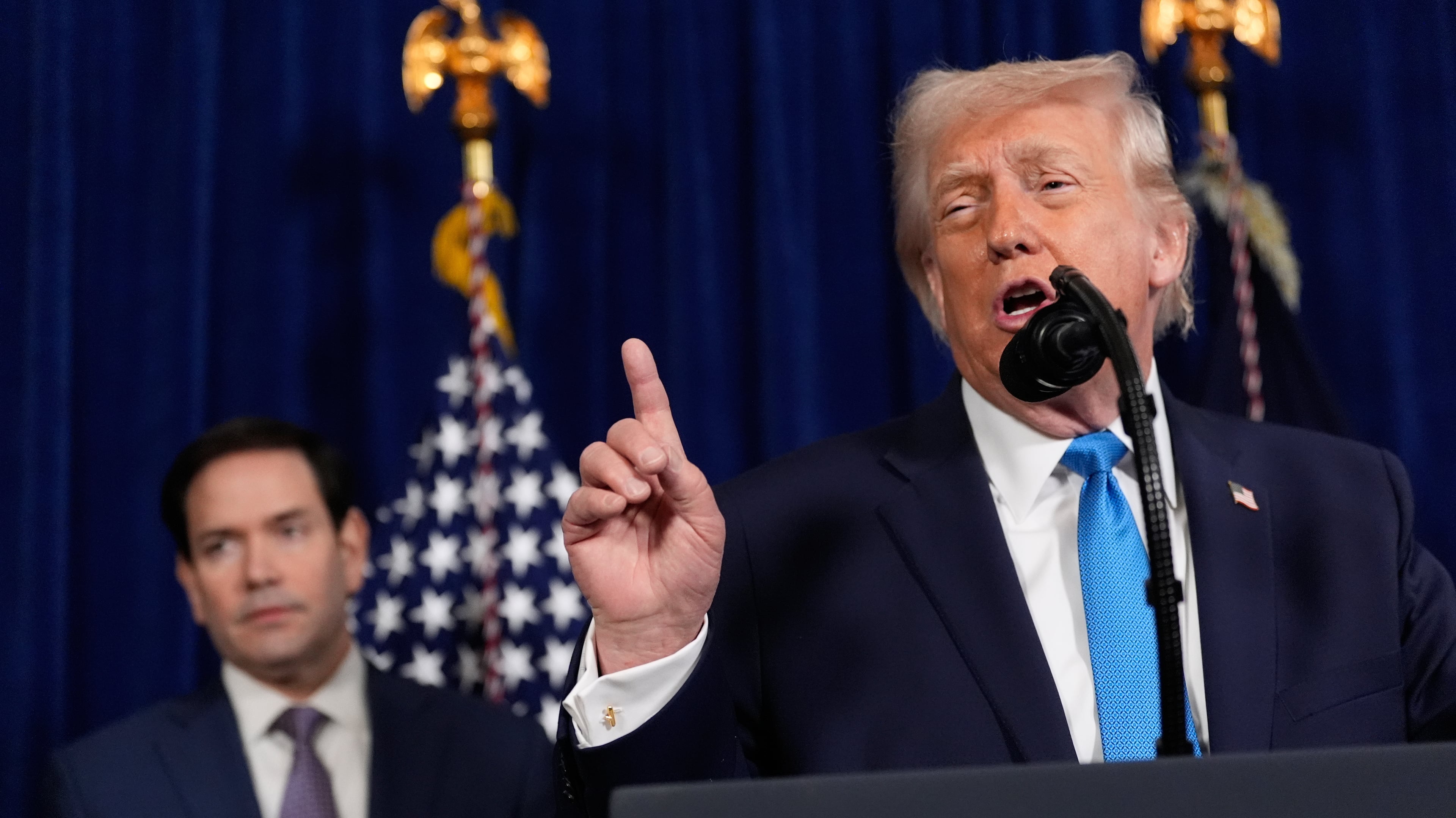 President Donald Trump speaks during a news conference at Mar-a-Lago, Saturday, Jan. 3, 2026, in Palm Beach, Fla., as Secretary of State Marco Rubio listens. (AP Photo/Alex Brandon)