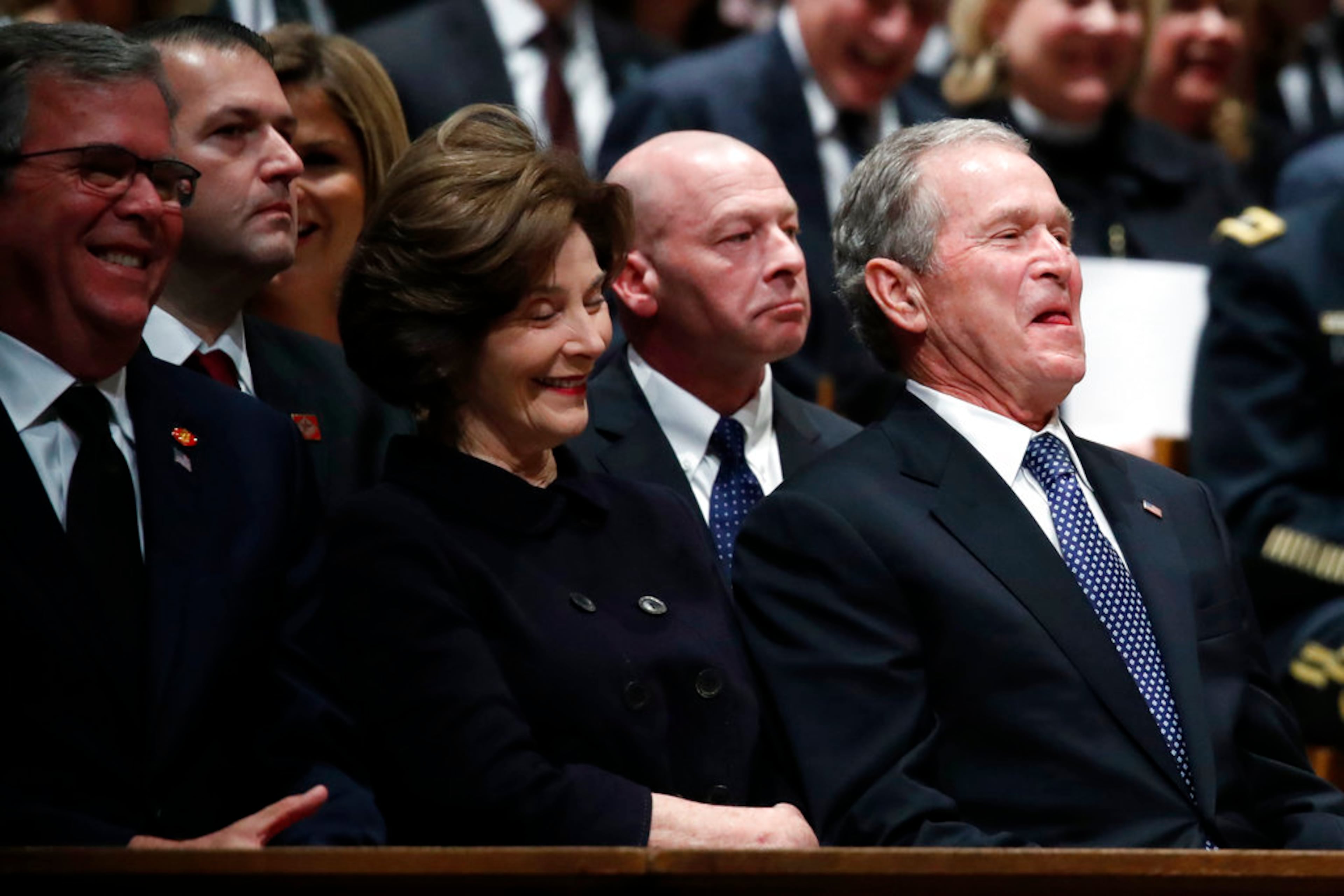 Former Florida Gov. Jeb Bush, Laura Bush and former President George W. Bush smile during a State Funeral for former President George H.W. Bush at the Washington National Cathedral, Wednesday, Dec. 5, 2018, in Washington. (AP Photo/Alex Brandon, Pool)