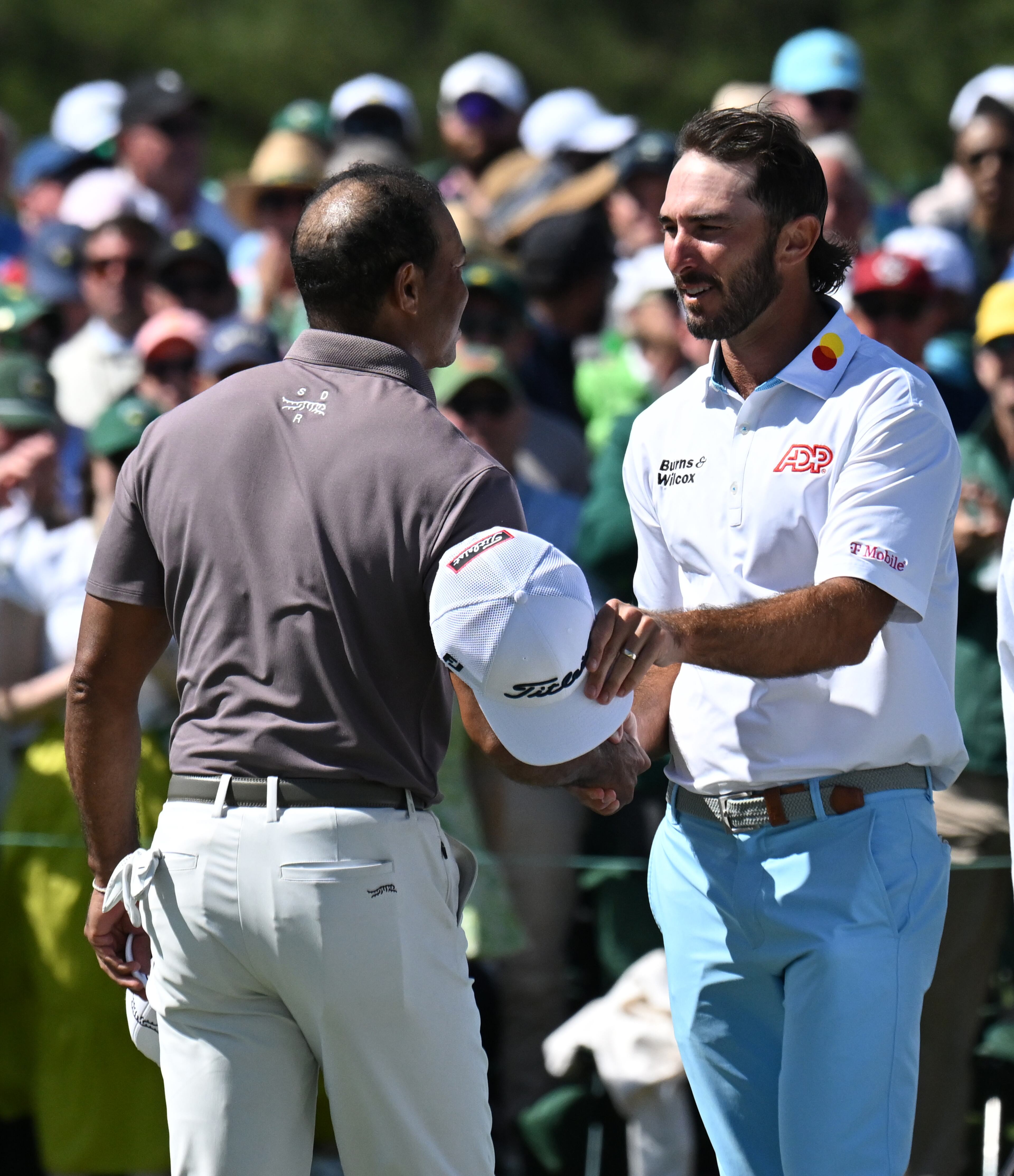 Max Homa and Tiger Woods shake hands at the end of the second round of the 2024 Masters Tournament at Augusta National Golf Club, Friday, April 12, 2024, in Augusta, Ga. (Hyosub Shin / Hyosub.Shin@ajc.com)
