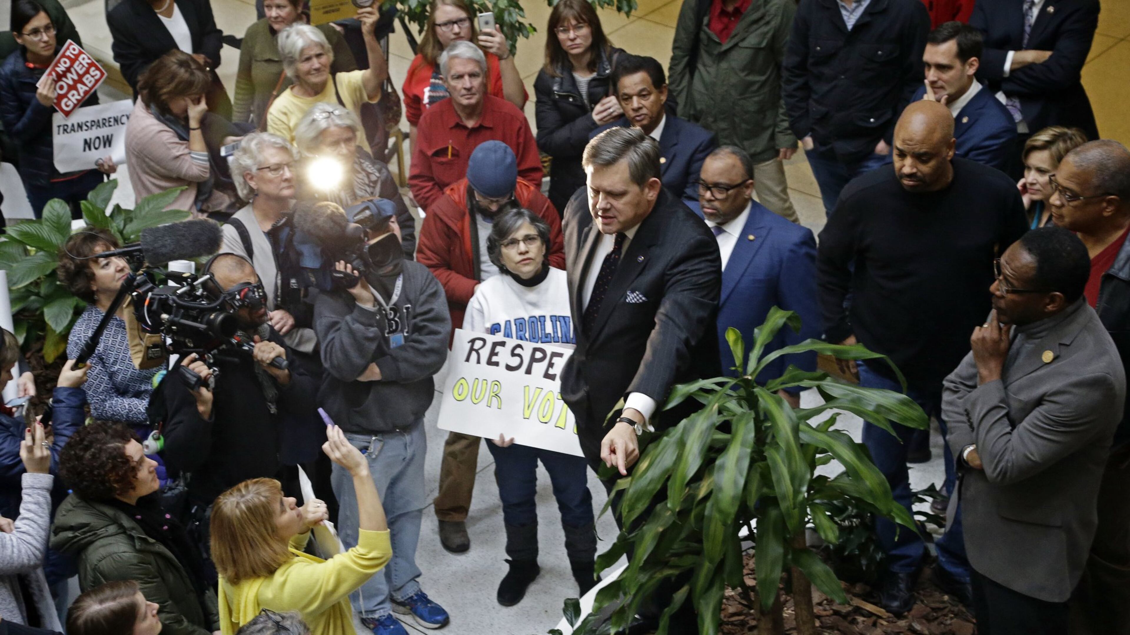 North Carolina Sen. Mike Woodard, D-Durham, addresses a crowd of demonstrators during a special session at the North Carolina Legislature in Raleigh, N.C., Thursday, Dec. 15, 2016. (AP Photo/Gerry Broome)