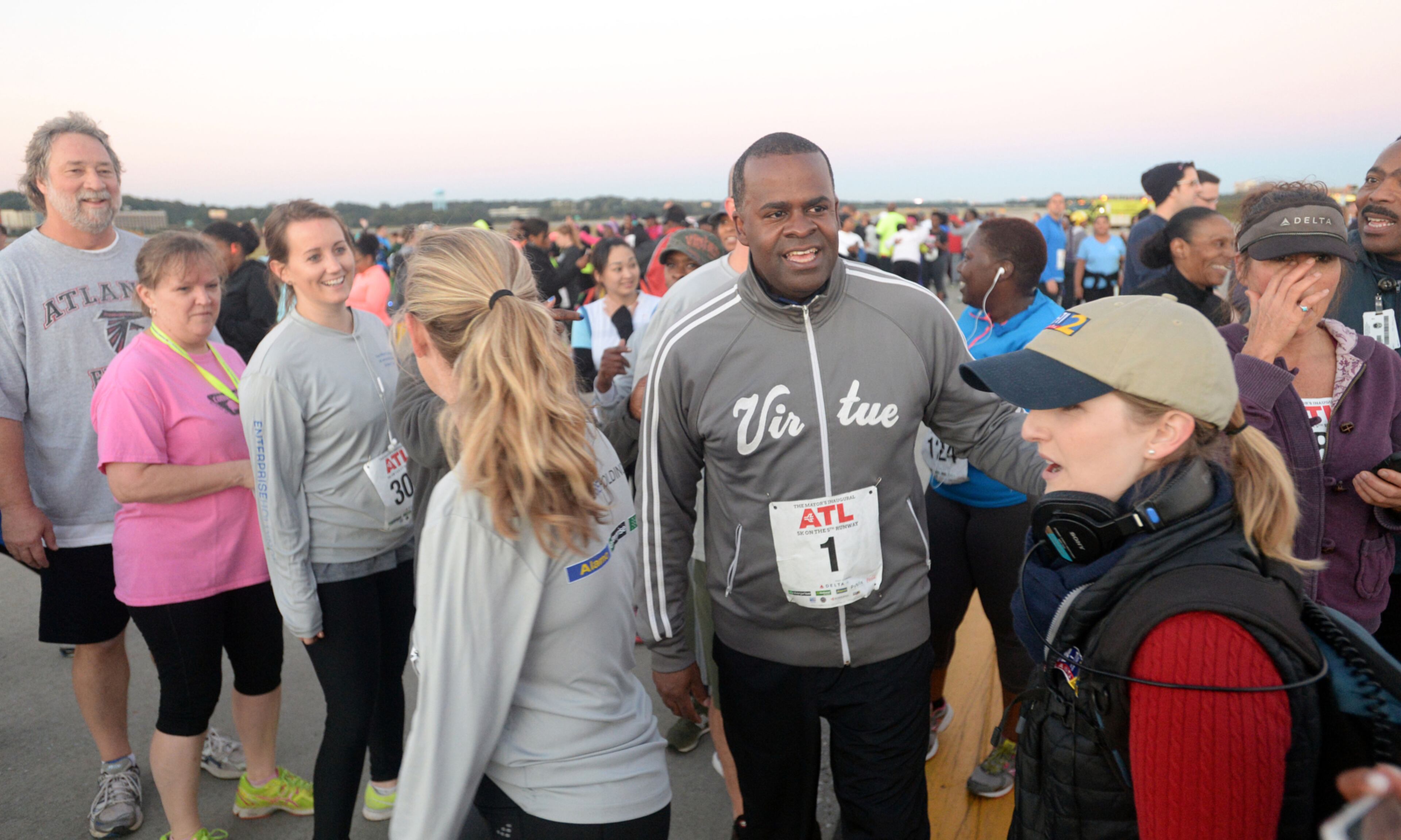 OCTOBER 17, 2015 ATLANTA Mayor Kasim Reed greets runners after finishing. Reed and United Way President Milton Little joined more than 2,000 runners at the Mayor’s Inaugural 5K on the 5th Runway at the world’s busiest airport Saturday, October 17, 2015. Airport officials shut down the 5th runway (Runway 10/28) until 8:15 am so runners and walkers could exit the course. All proceeds from the event will benefit United Way of Greater Atlanta. Major sponsors of The Mayor’s Inaugural 5K on the 5th Runway include Delta Air Lines, The Coca-Cola Company, Enterprise Rental Car, Georgia International Convention Center, MARTA, and Publix. Over $123,000 was raised, said airport spokesman Reese McCranie. The race's overall winner was Andrew Murfee, 15, a Woodward Academy student. KENT D. JOHNSON/KDJOHNSON@AJC.COM