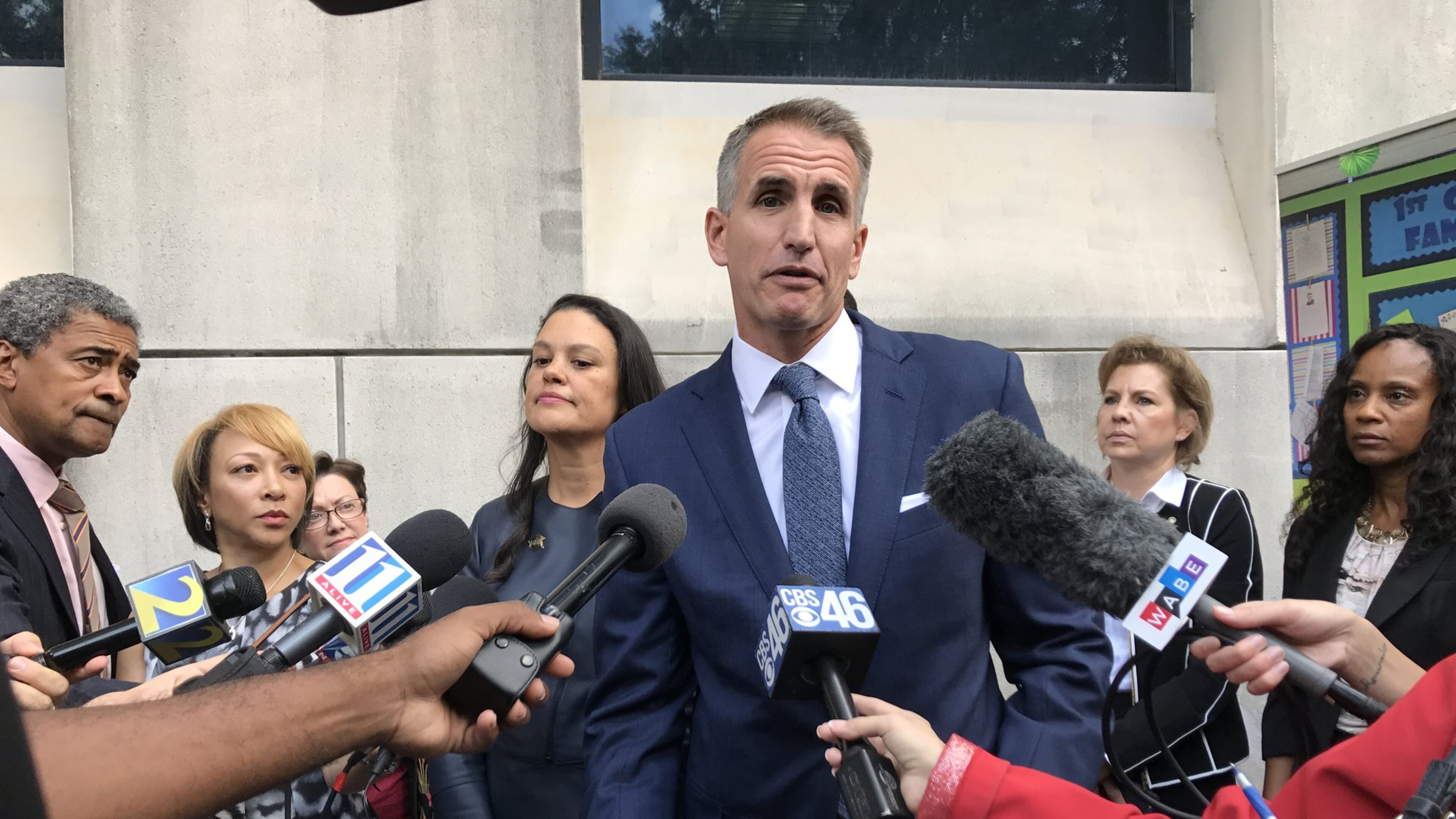Fulton County Schools Superintendent Jeff Rose, center, and Atlanta Public Schools Superintendent Meria Carstarphen, left, talk to reporters outside Superior Court of Fulton County on Nov. 3, after a judge ordered a temporary tax collection in Fulton County. AJC FILE PHOTO