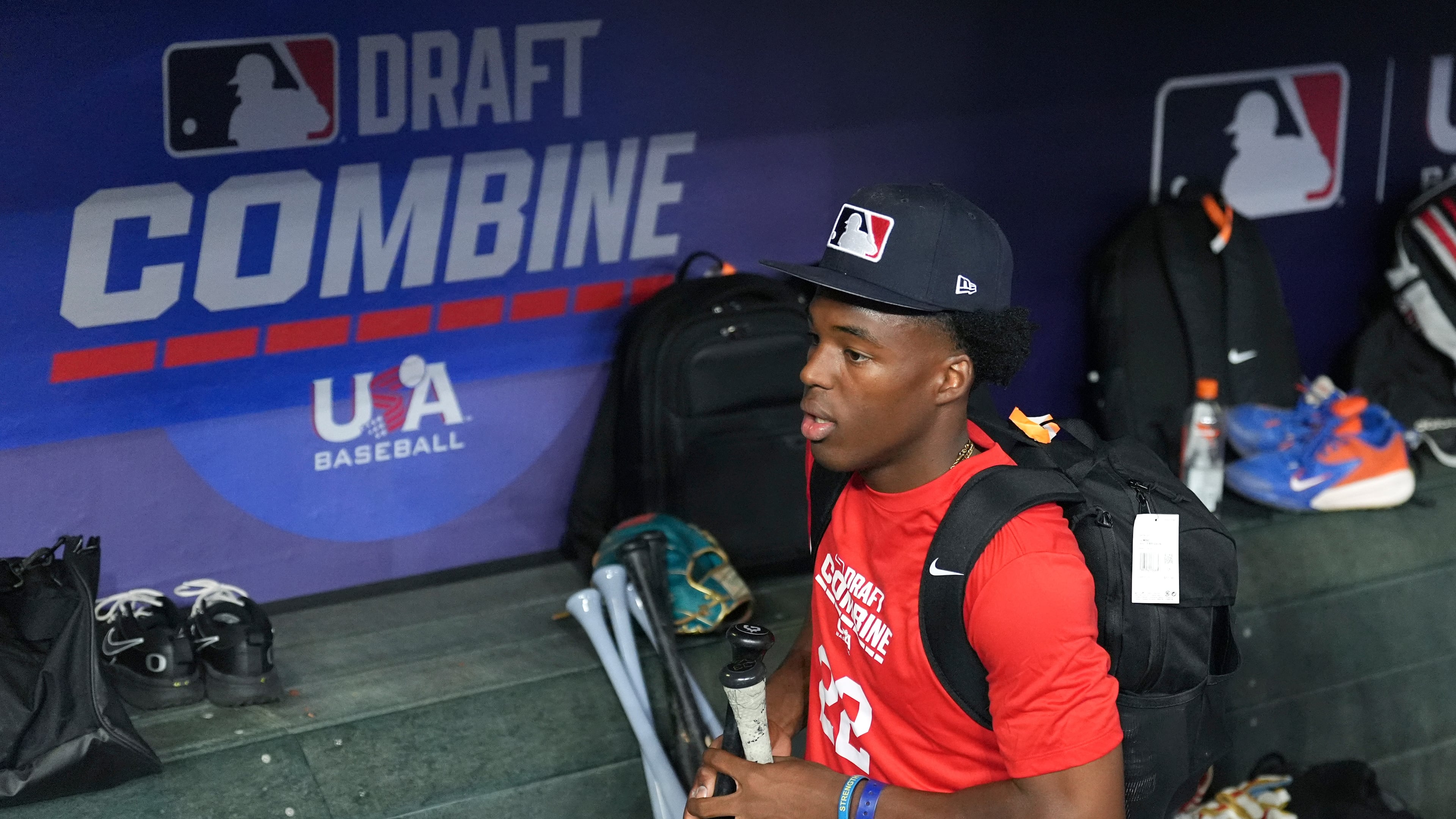 James Clark, a shortstop from St. John Bosco High School, gathers his gear in the dugout at the MLB baseball combine in Phoenix, Tuesday, June 23, 2026. (AP Photo/Ross D. Franklin)
