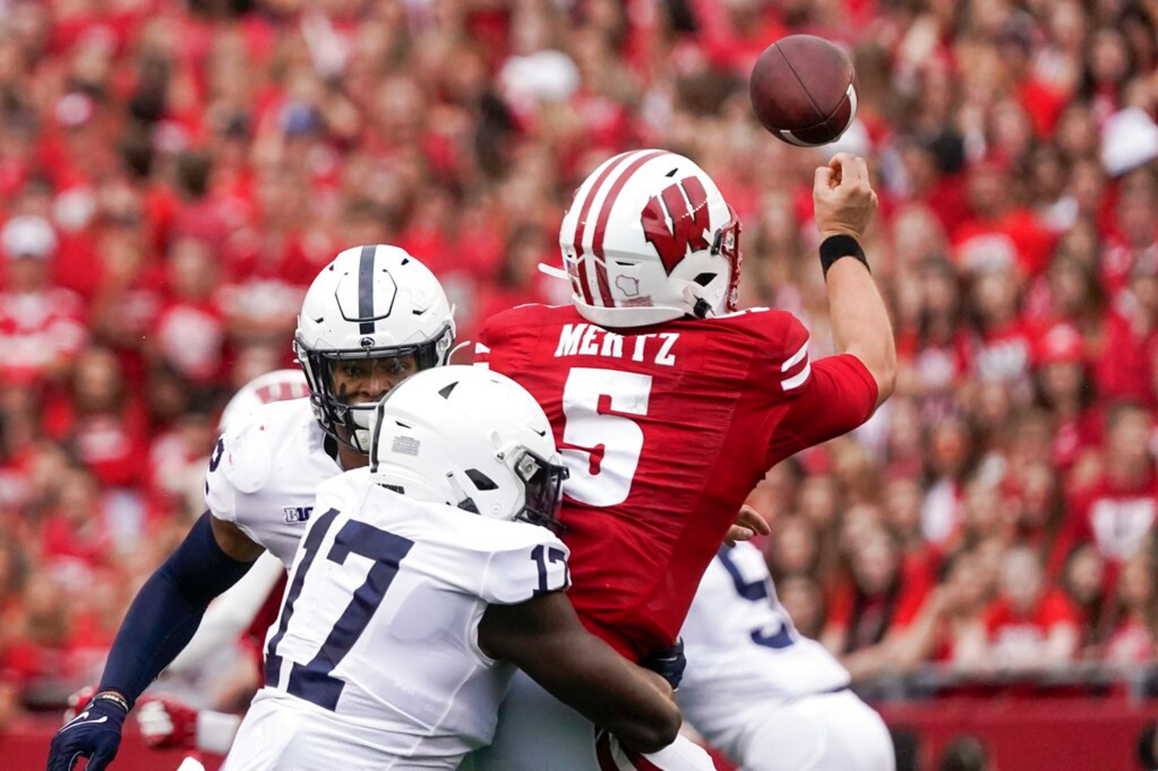 Penn State's Arnold Ebiketie hits Wisconsin's Graham Mertz as he throws during the first half of an NCAA college football game Saturday, Sept. 4, 2021, in Madison, Wis. (AP Photo/Morry Gash)