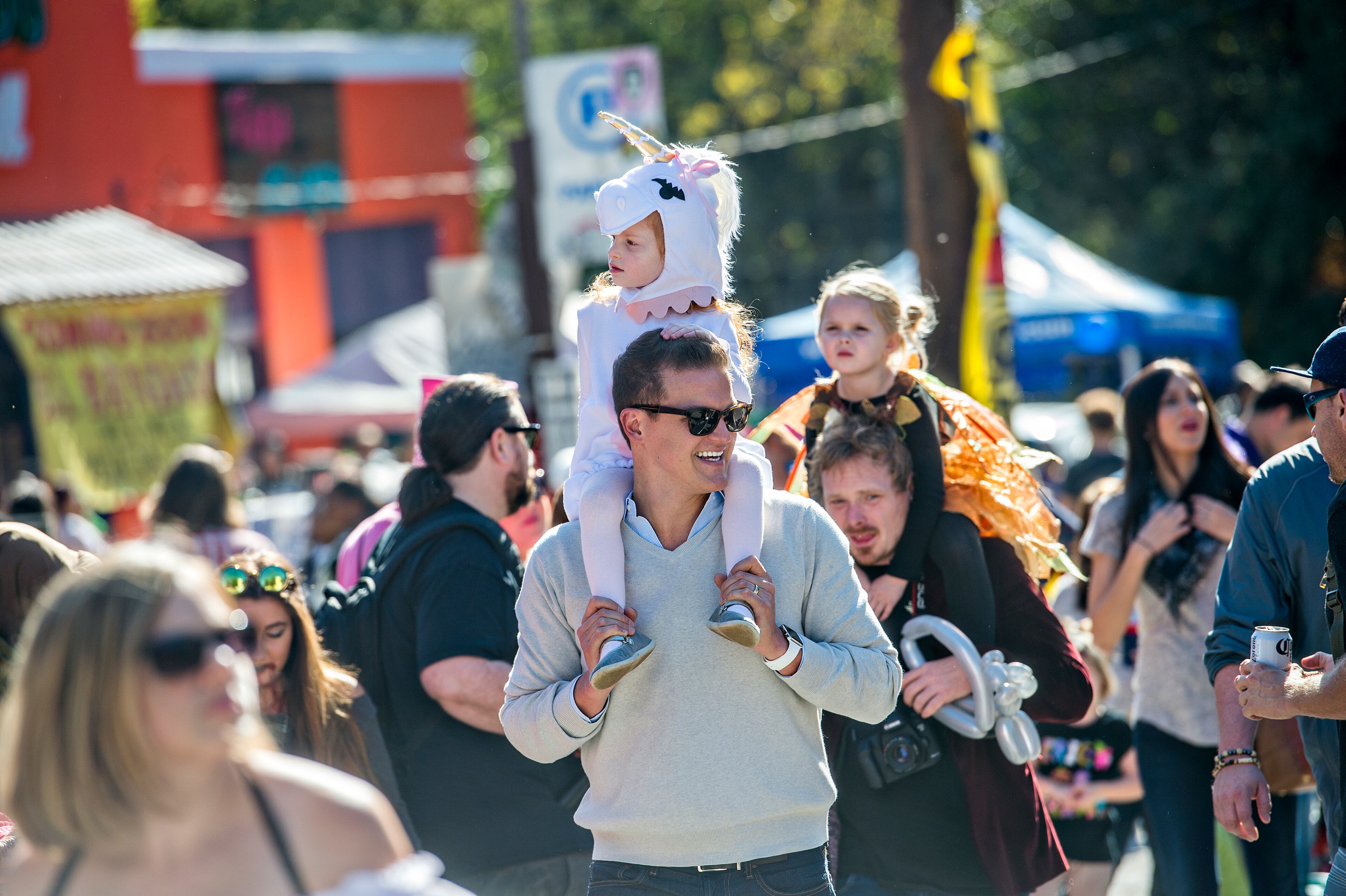 October 17, 2015 Atlanta - Monet Aouad (center) rides on her father Robert's shoulders as they look for a spot to watch the Little Five Points Halloween Parade in Atlanta on Saturday, October 17, 2015. The annual parade brought out tens of thousands of people to watch the antics. JONATHAN PHILLIPS / SPECIAL