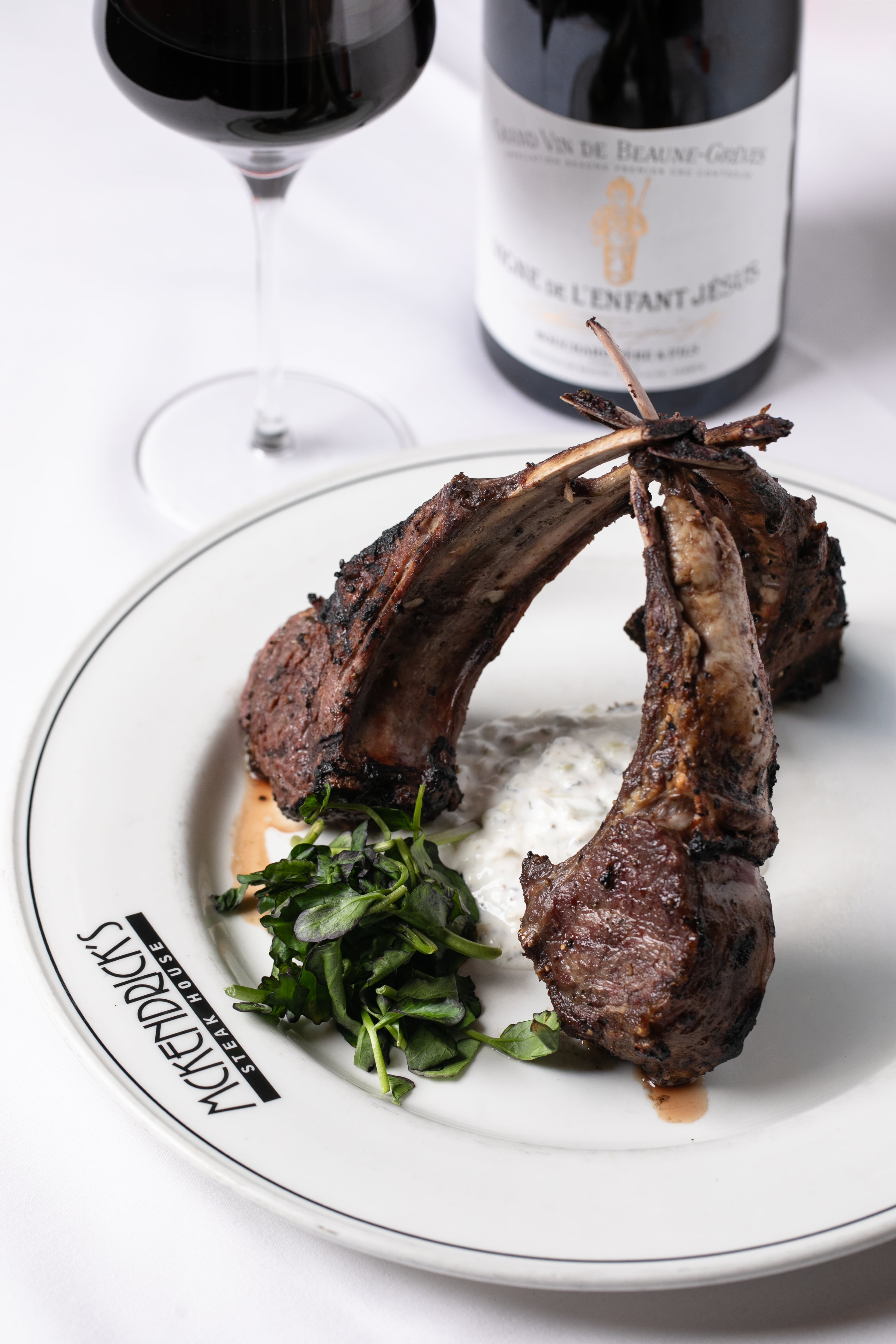 The lamb chops at McKendrick's are served over bed of tzatziki sauce. (Erik Meadows Photography/Courtesy of McKendrick's Steakhouse & Bar)