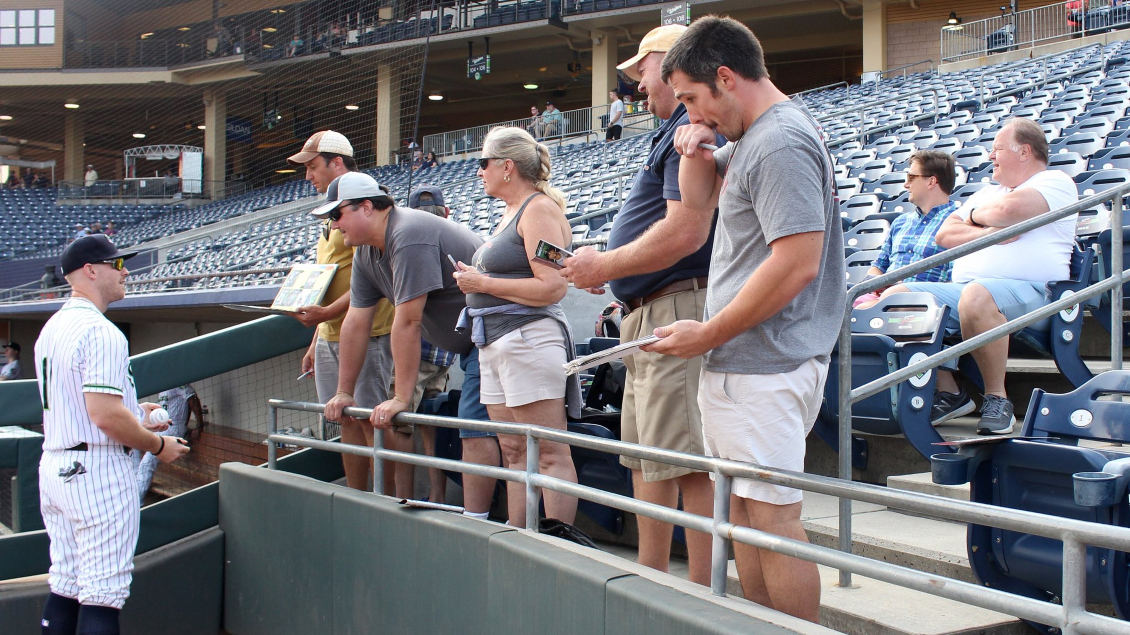 Gwinnett Stripers’ Michael Reed signs autographs for Stripers fans before their game against the Louisville Bats in a minor league baseball game at Coolray Field on Monday, August 13, 2018, in Lawrenceville. JENNA EASON / JENNA.EASON@COXINC.COM