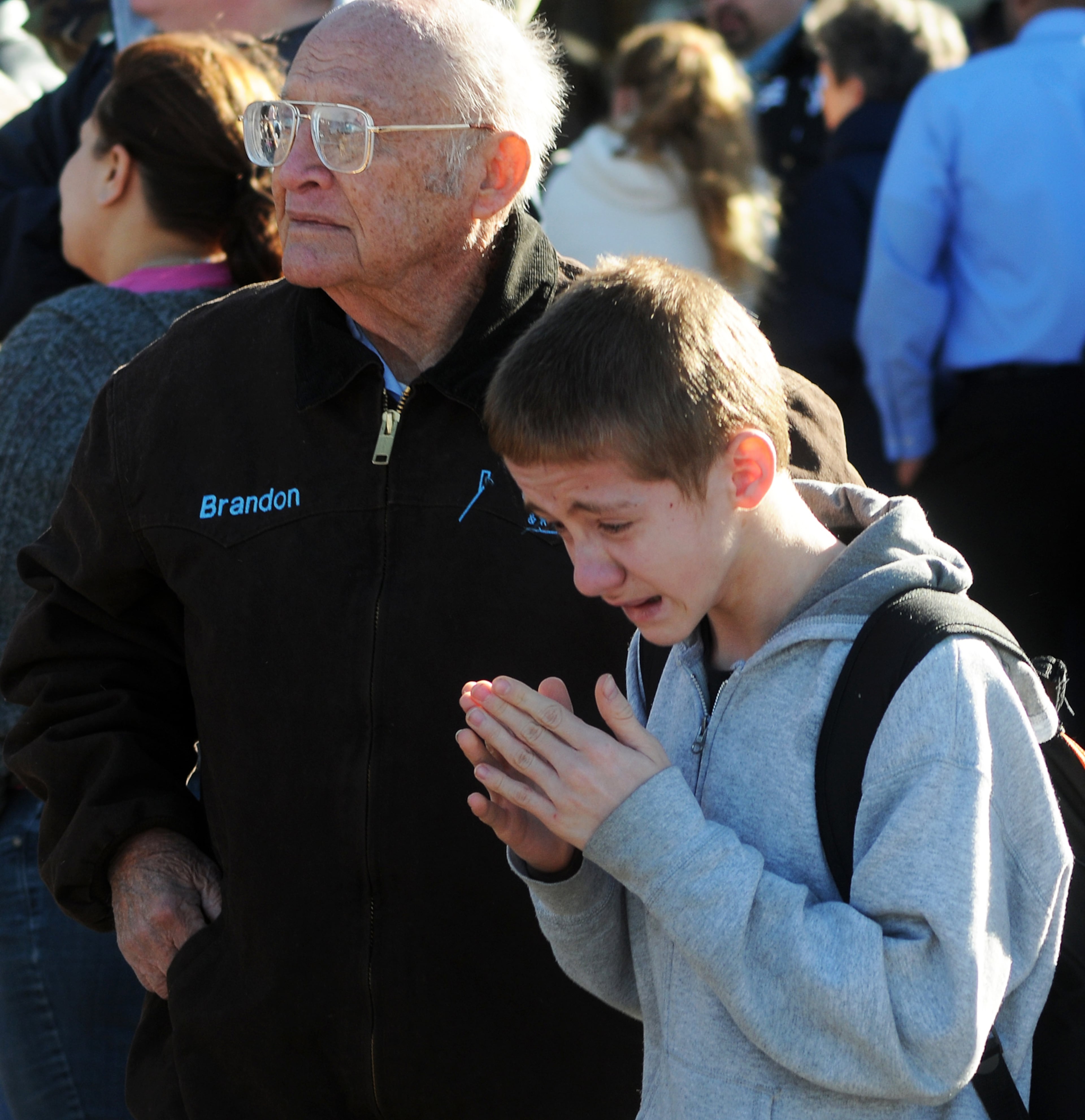 A student, right, waits at a staging ground area set up at the Roswell Mall following a shooting at Berrendo Middle School on Jan. 14, 2014, in Roswell, N.M.