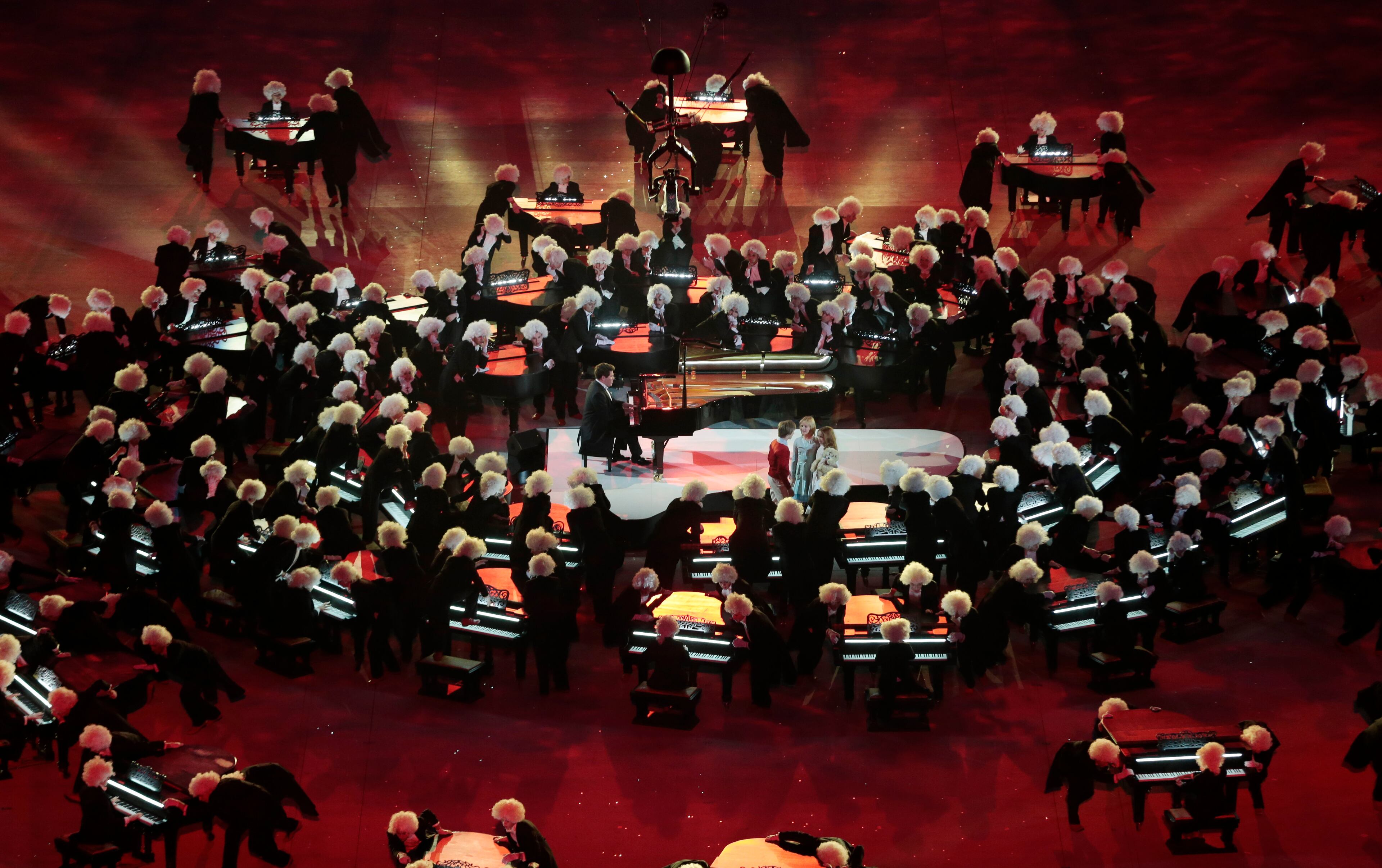 Piano players perform around pianist Denis Matsuev during the closing ceremony of the 2014 Winter Olympics, Sunday, Feb. 23, 2014, in Sochi, Russia. (AP Photo/Ivan Sekretarev)