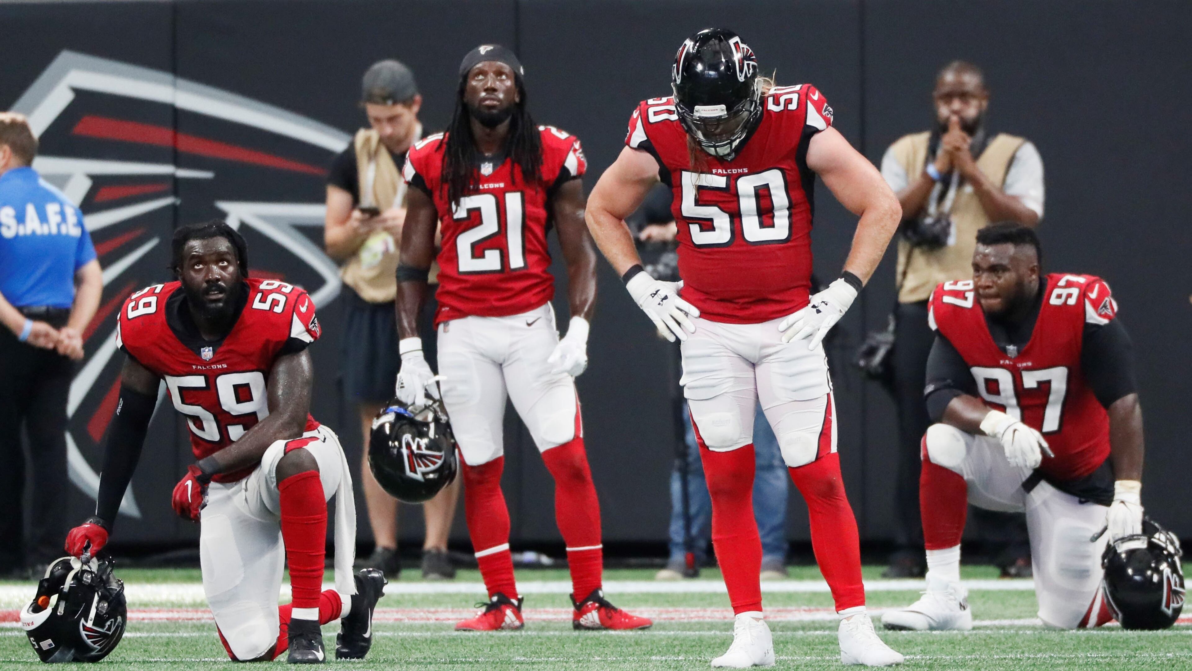 Falcons linebacker De'Vondre Campbell (59), defensive back Desmond Trufant (21), defensive end Brooks Reed (50) and defensive tackle Grady Jarrett (97) react after the Saints scored an apparent touchdown to win in OT on Sept. 23. It was ruled short of the goal line but the Saints went on to score on the next play. BOB ANDRES /BANDRES@AJC.COM