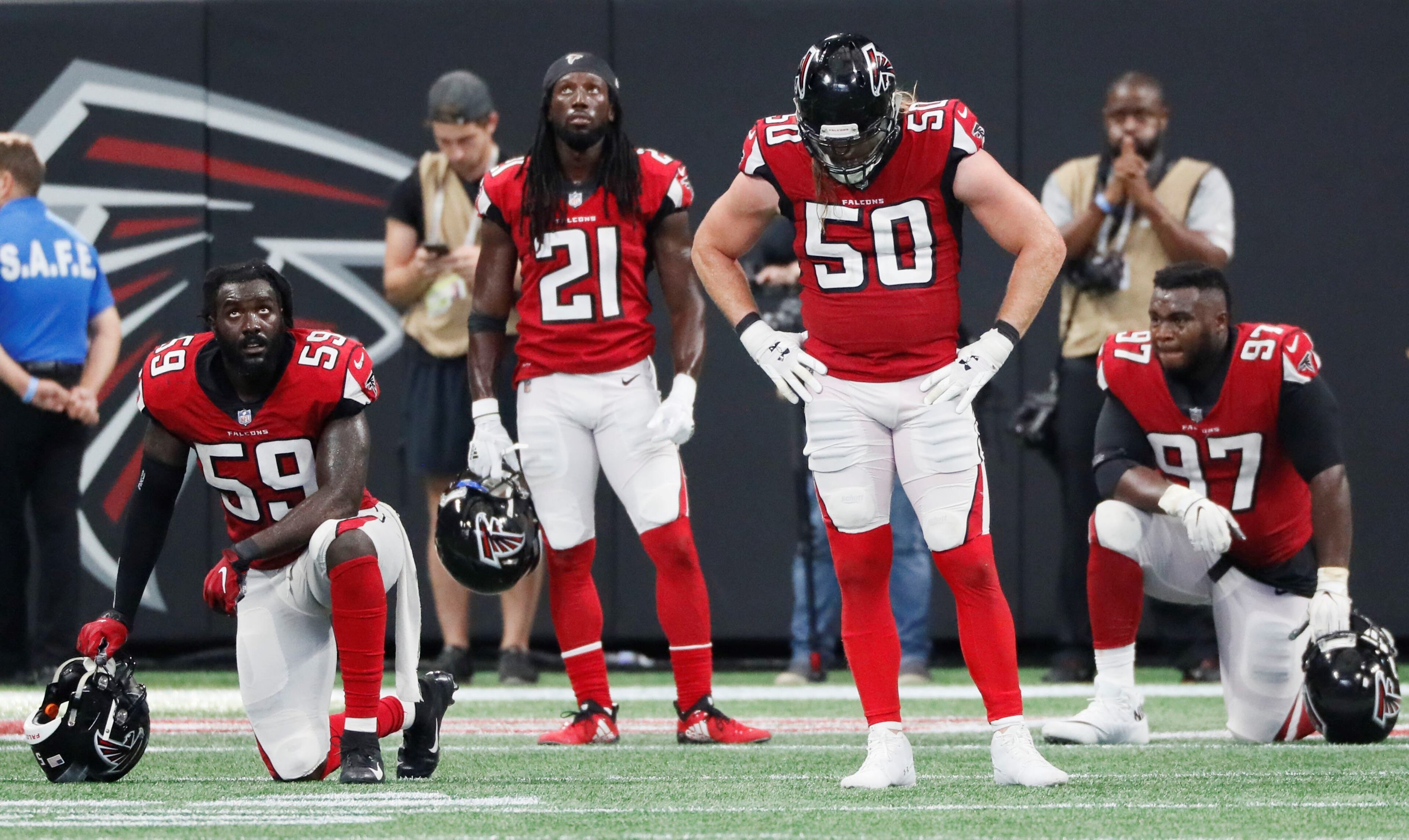 9/23/18 - Atlanta - Atlanta Falcons linebacker De'Vondre Campbell (59), Atlanta Falcons defensive back Desmond Trufant (21), Atlanta Falcons defensive end Brooks Reed (50) and Atlanta Falcons defensive tackle Grady Jarrett (97) react after the Saint's scored an apparent touchdown to win in OT. It was ruled short of the goal line but the Saint's went on to score on the next play. The Atlanta Falcons played the New Orleans Saints in an NFL football game Sunday, Sept 23, 2018, at Mercedes-Benz Stadium in Atlanta, GA. BOB ANDRES /BANDRES@AJC.COM