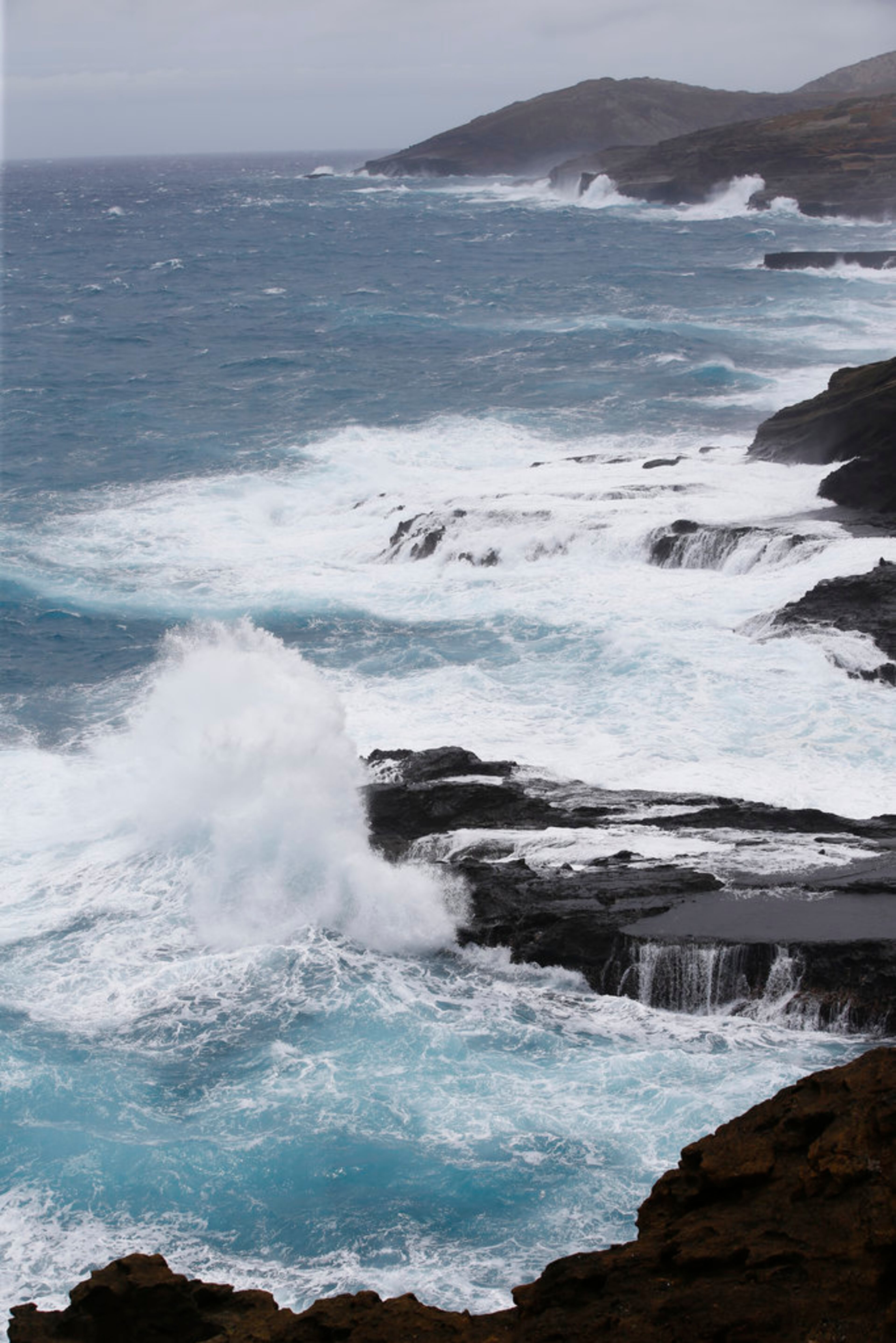 Huge waves slam the cliffs near the Halona Blowhole, Friday, Aug. 24, 2018, in Waimanalo, Hawaii. As Hurricane Lane approaches Oahu, large oceans swells have impacted the coastline. (AP Photo/Marco Garcia)