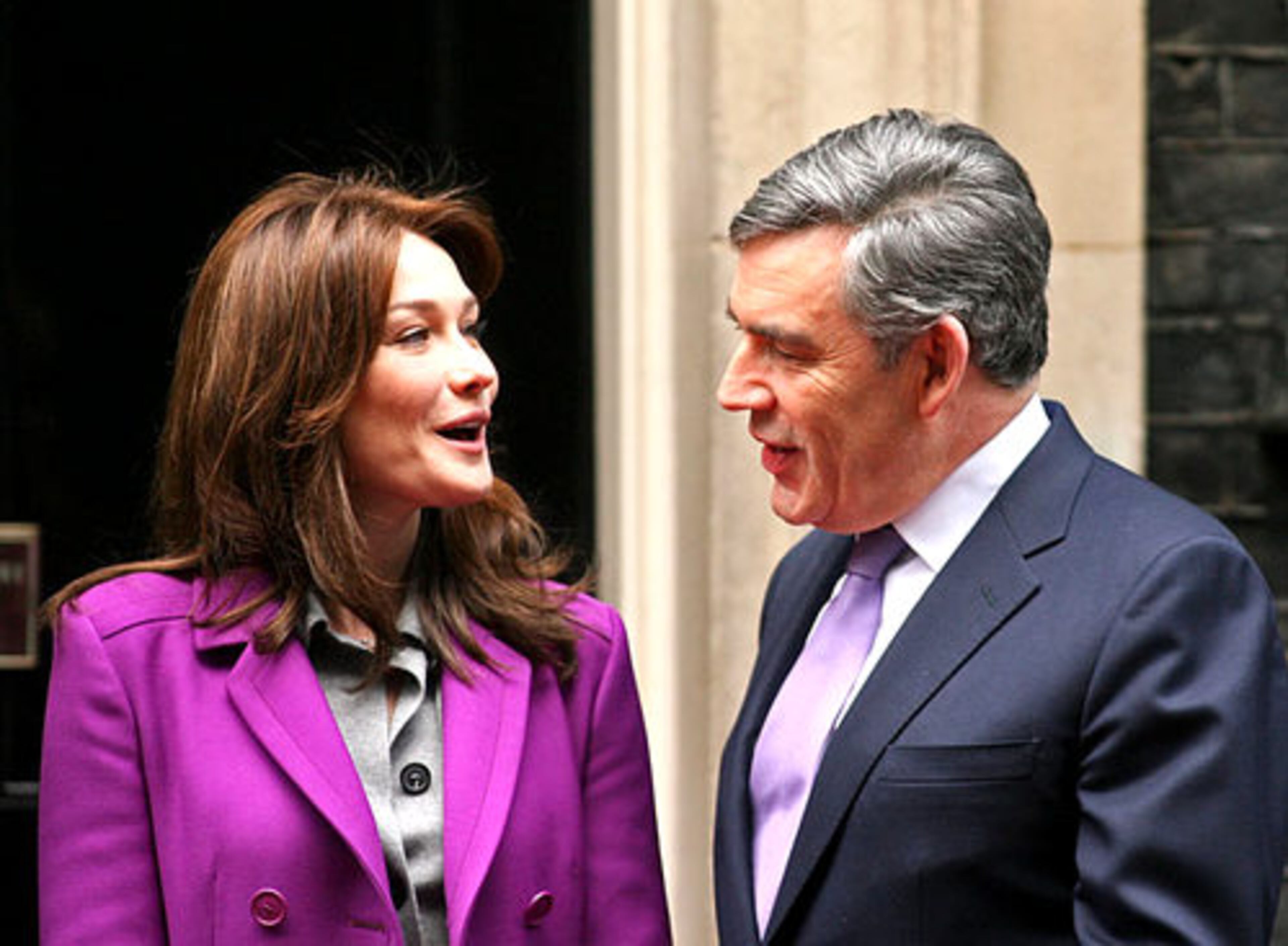 Bruni-Sarkozy talks with British Prime Minister Gordon Brown as they arrive at 10 Downing St., the home and office of the prime minister, in London.