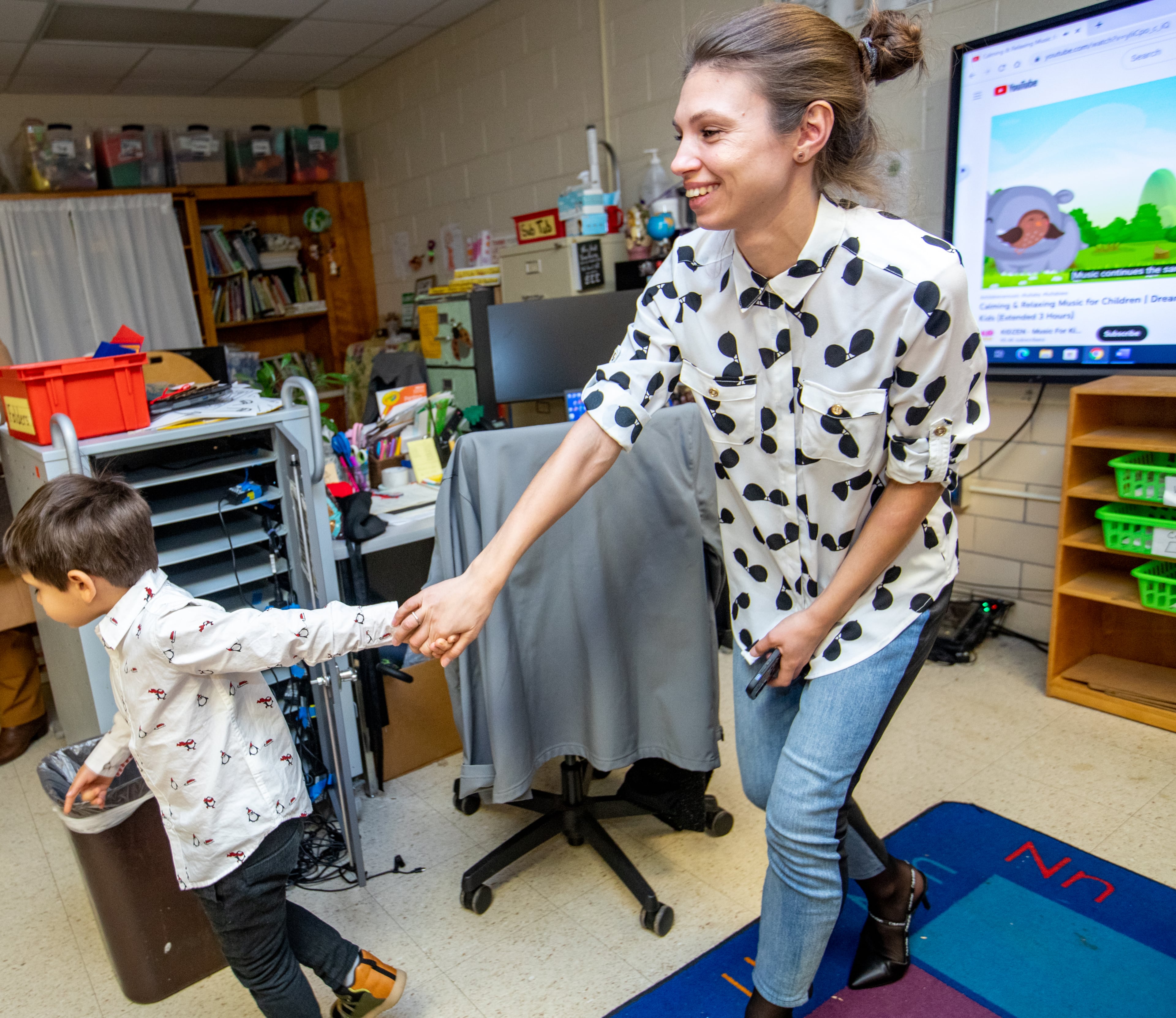 Oleksandra Slasna is taken by her 5-year-old son Yurii Slasnyi from his kindergarten classroom to join him for snacks at Briar Vista Elementary School on Thursday, Dec 15, 2022 after the school's holiday performance. The Ukraine refugees are working to secure healthcare, housing and other basics. Oleksandra gets emotional seeing her son in his classroom for the first time. (Jenni Girtman for The Atlanta Journal-Constitution)
