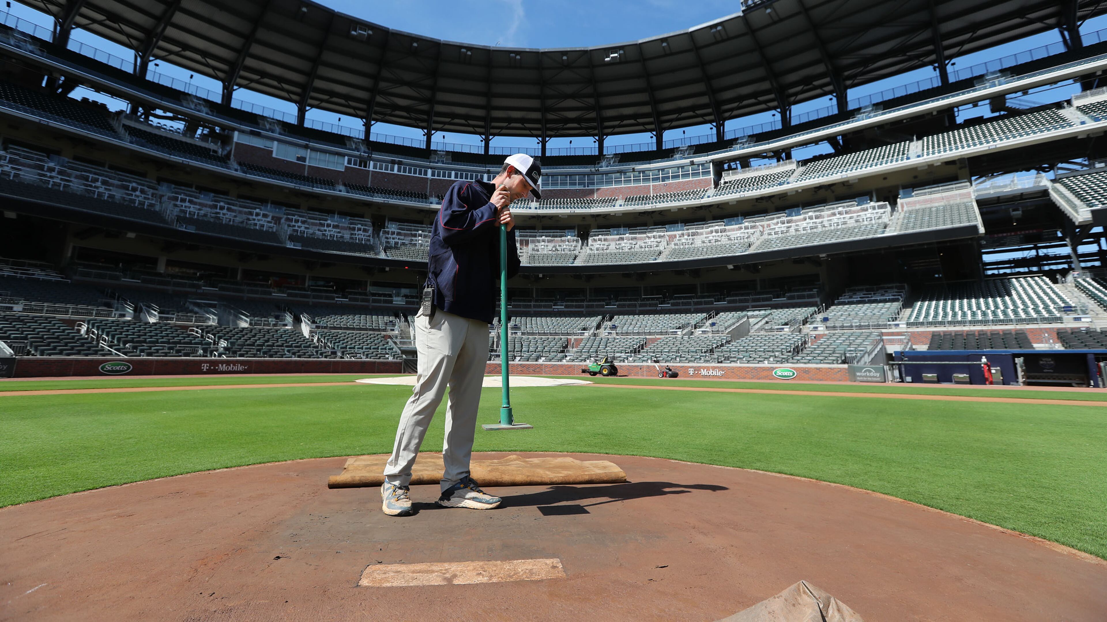 Braves field manager Tyler Lenz tamps down the pitcher's mound while maintaining the quality of the field at Truist Park during baseball’s continuing shutdown.
