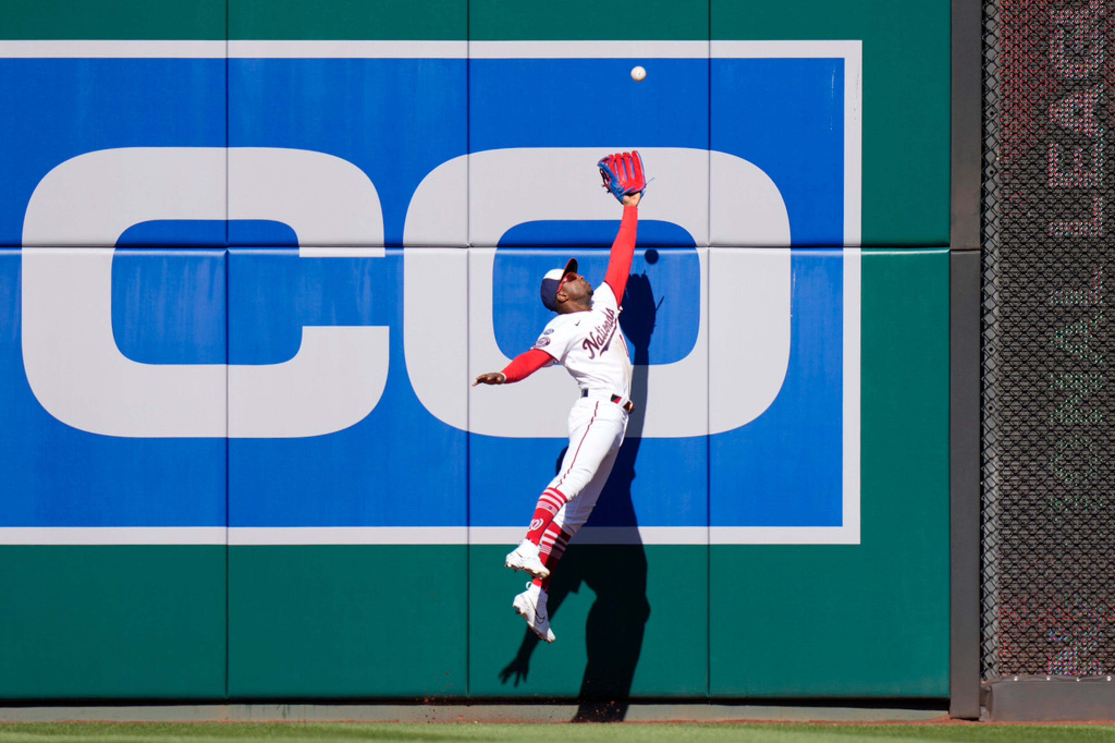 Washington Nationals center fielder Victor Robles prepares to catch a fly ball that was hit by Atlanta Braves' Ronald Acuna Jr. during the ninth inning of an opening day baseball game at Nationals Park, Thursday, March 30, 2023, in Washington. (AP Photo/Alex Brandon)
