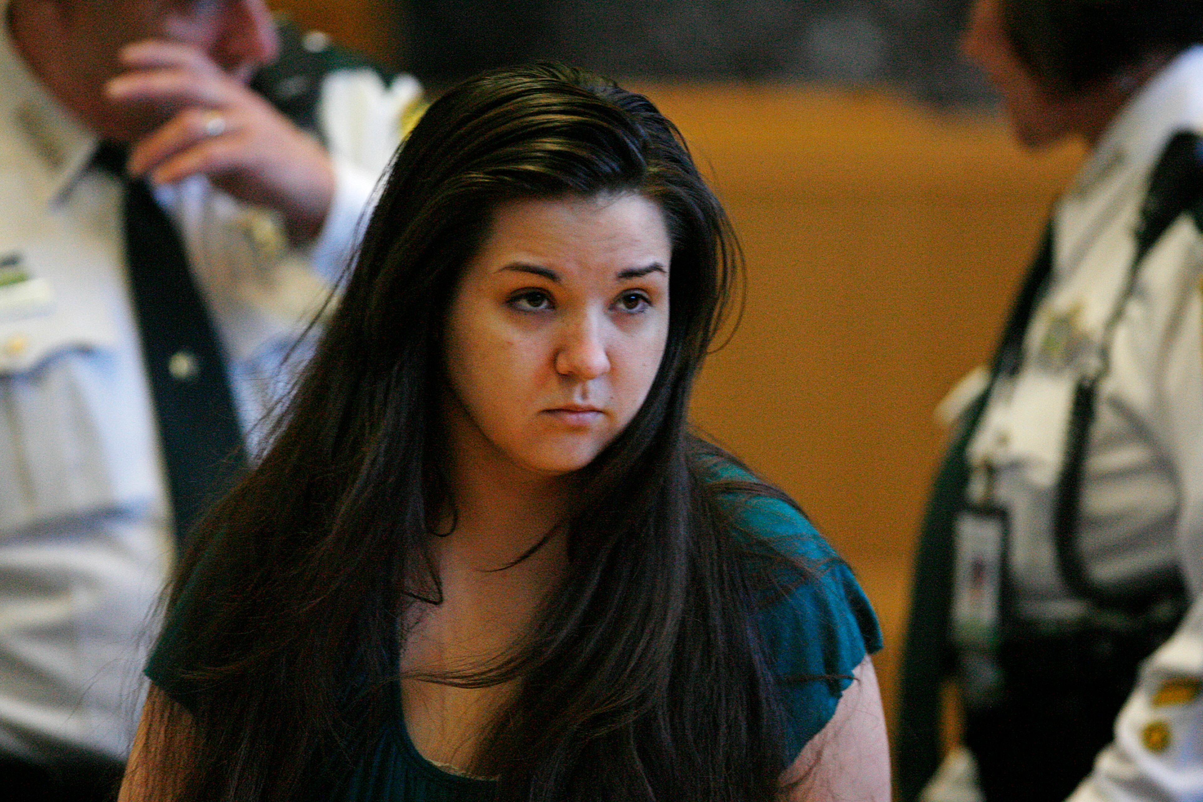 Jennifer Mee, center, looks at potential jurors as jury selection begins her murder trial, Tuesday, Sept. 17, 2013, at the Pinellas County Justice Center in Clearwater, Fla. Mee, 22, who found fame in 2007 as a teen because of her uncontrollable hiccupping, is charged with first-degree murder in the 2010 death of Shannon Griffin. (AP Photo/The Tampa Bay Times, Scott Keeler, Pool)