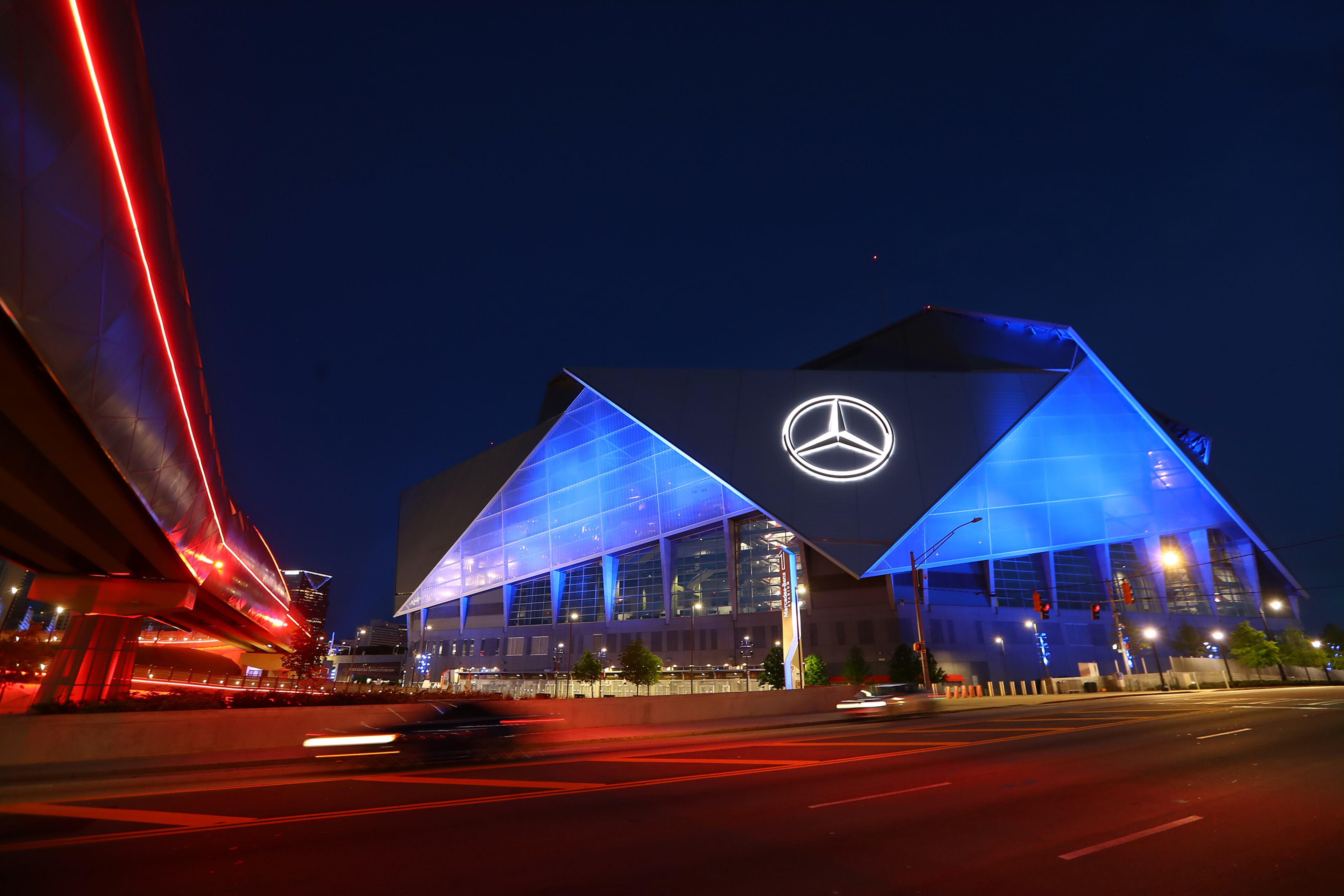 Mercedes-Benz Stadium transforms into a beacon of blue as part of an initiative to salute essential workers on the frontlines of the coronavirus pandemic on Thursday. Curtis Compton ccompton@ajc.com