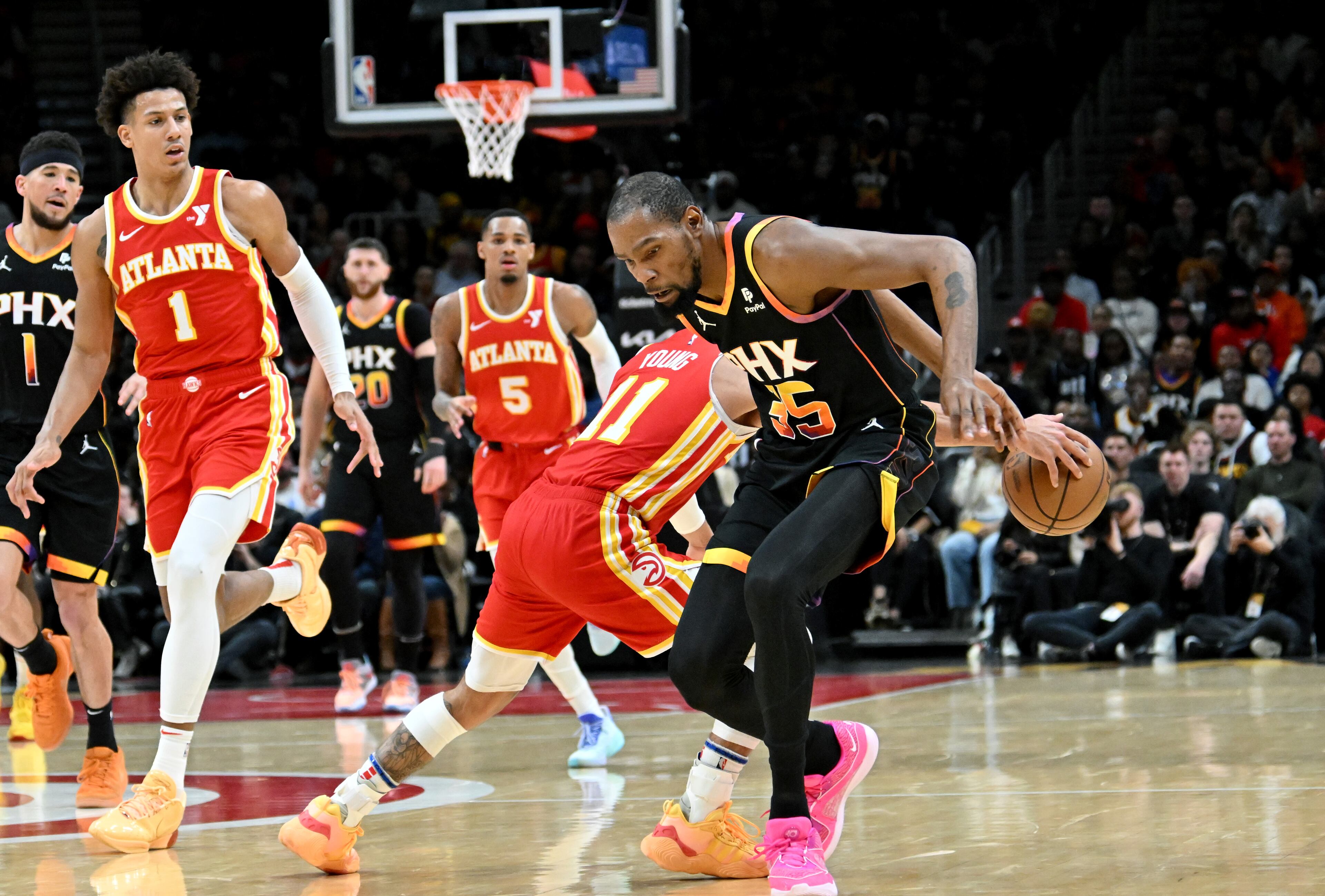 Atlanta Hawks guard Trae Young (11) steals the ball from Phoenix Suns forward Kevin Durant (35) during the second half. (Hyosub Shin / Hyosub.Shin@ajc.com)
