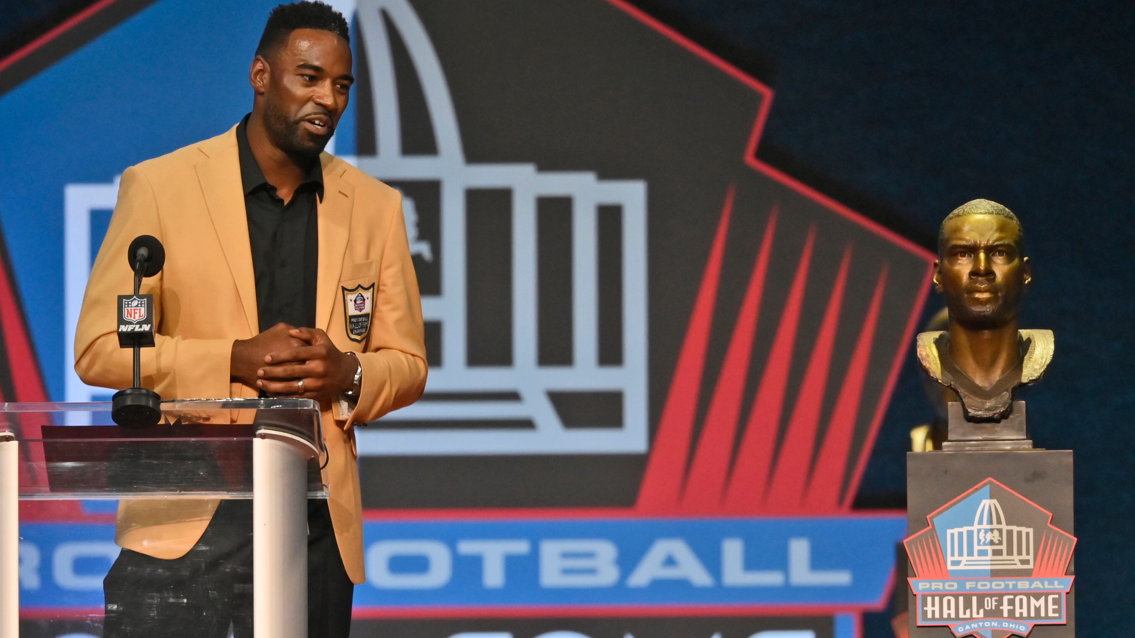 Calvin Johnson, a member of the Pro Football Hall of Fame Class of 2021, speaks during the induction ceremony at the Pro Football Hall of Fame, Sunday, Aug. 8, 2021, in Canton, Ohio. (AP Photo/David Richard)