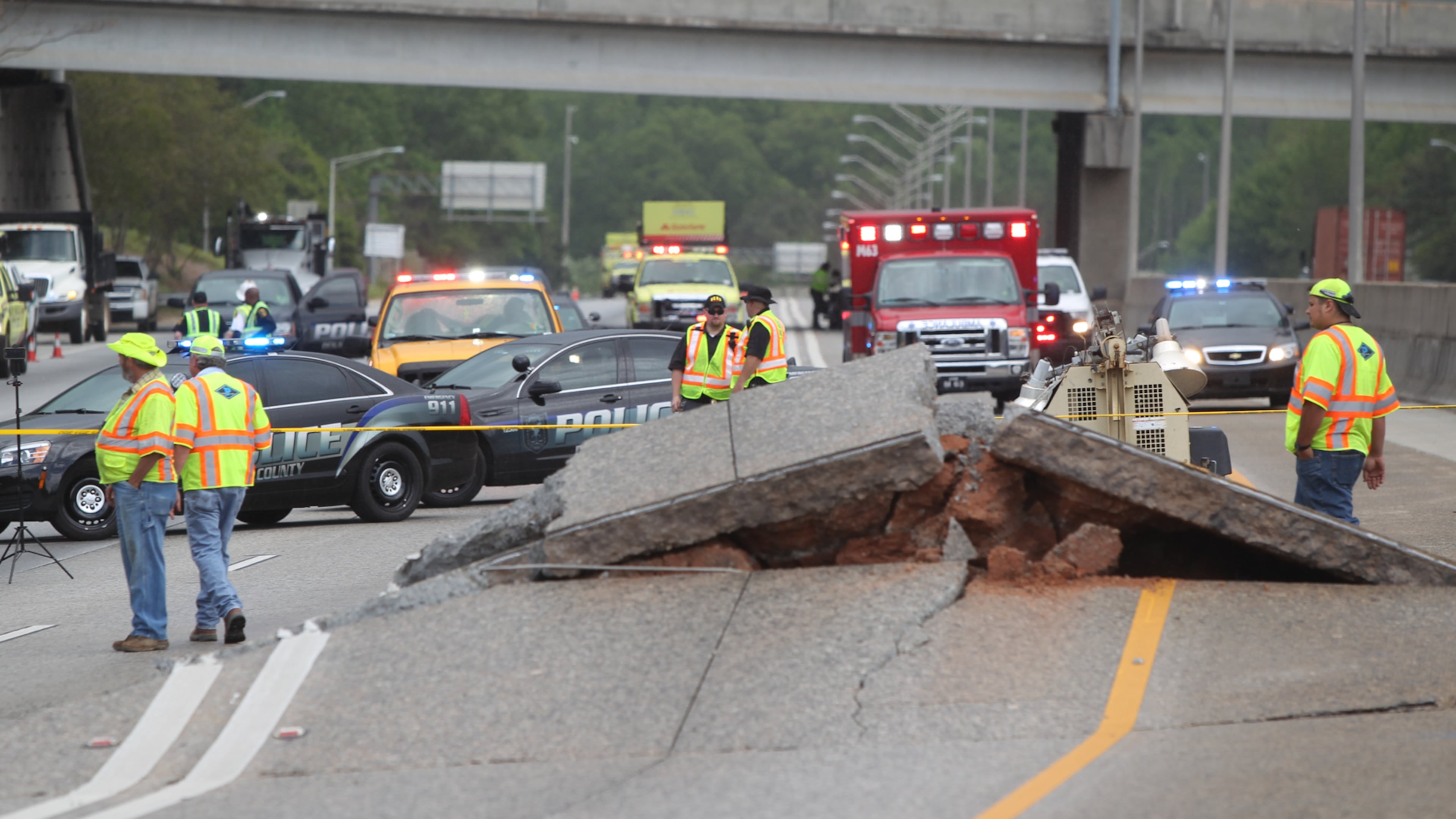 Crews continue to assess the road buckling on I-20 in the westbound lanes in Atlanta, Georgia, on April 17, 2017. According to the Dekalb County Fire Department there were private contractors working on a gas pipe running underneath the interstate.