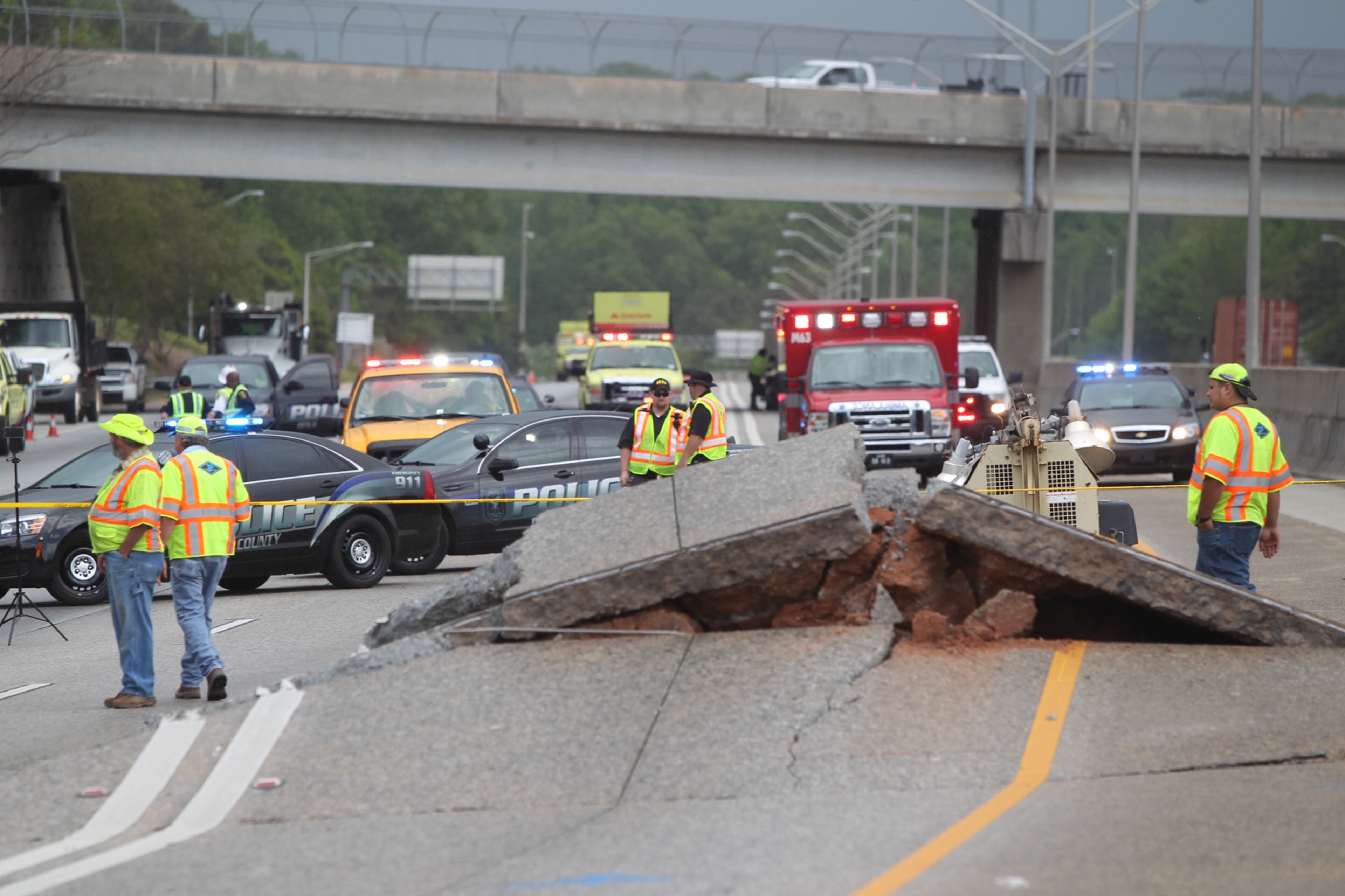 April 17, 2017, Atlanta, Georgia - Crews continue to assess the road buckling on I-20 in the west bound lanes in Atlanta, Georgia, on April 17, 2017. On the morning of April 17th a section of I-20 WB near the Gresham Road exit buckled. According to Dekalb County Fire Department PIO Eric Jackson there were private contractors working on a gas pipe running underneath the interstate. The private contractors were filling the pipe with cement when pressure started building up. According to Jackson the buckle acted as a pressure release valve. According to WSB-TV, they were told the rise of concrete was gradual and not sudden. In addition to all west bound lanes being closed while crews assess the situation, a motorcyclist may have crashed after running into the buckle, the driver of the motorcycle was taken to a local area hospital. (HENRY TAYLOR / HENRY.TAYLOR@AJC.COM)