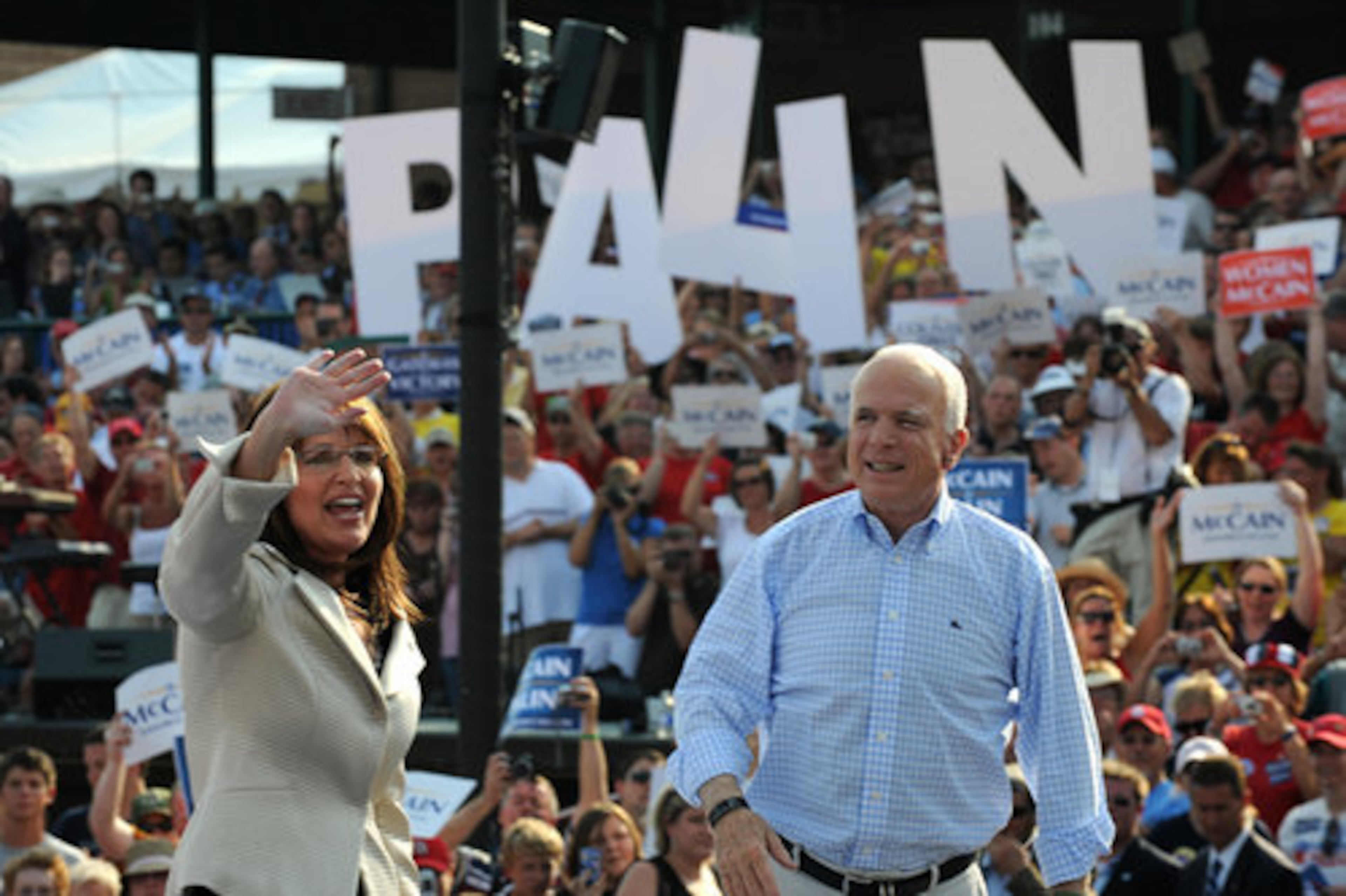 A sign supporting Palin provides the background for Republican presidential candidate John McCain and his running mate at a campaign event in O'Fallon, Mo.