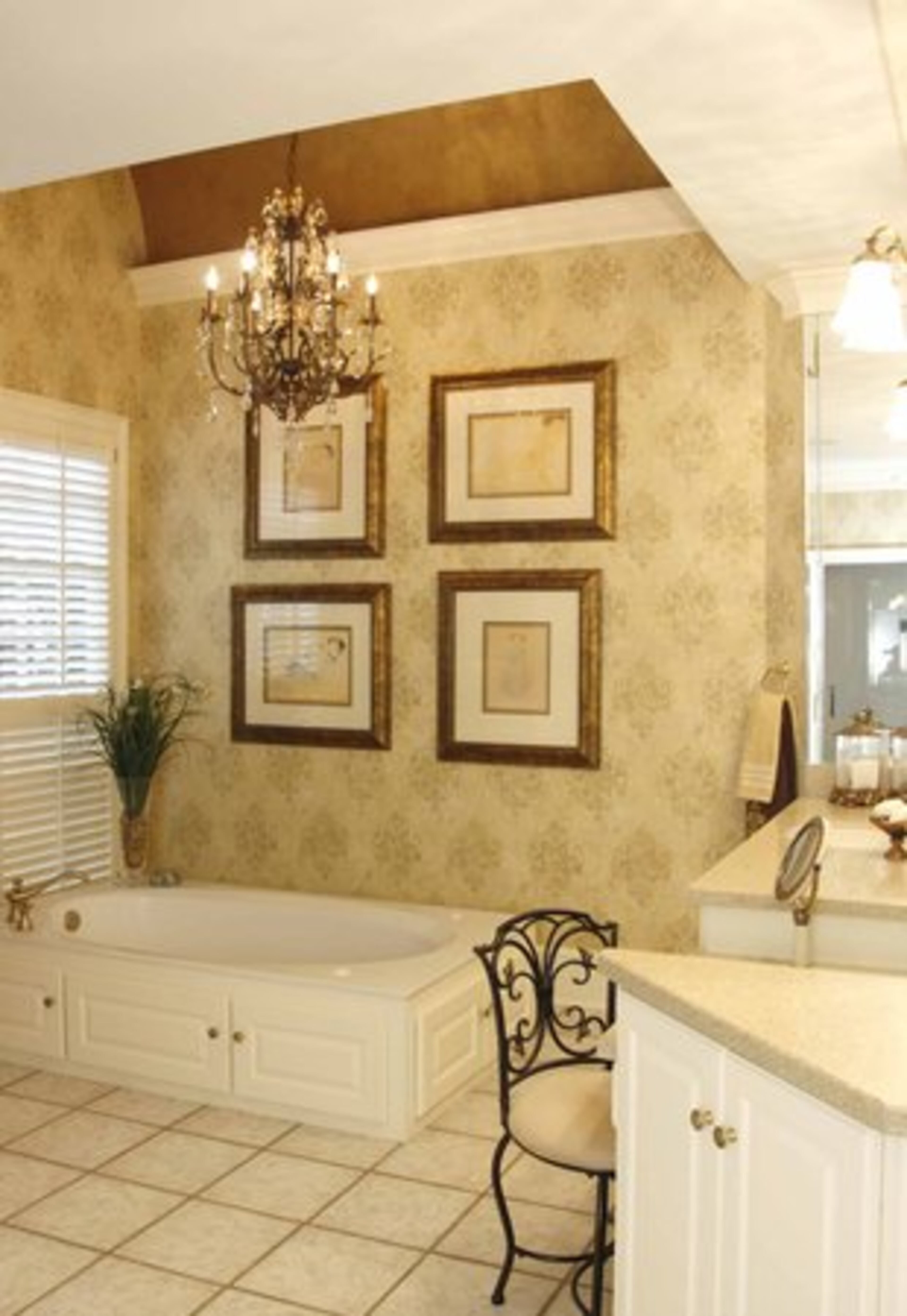 "Instead of ripping out cabinets we painted them a cream, changed knobs, put in stone surfaces, a new shower door and chandelier," explains Lisa of the updates to the master bath.