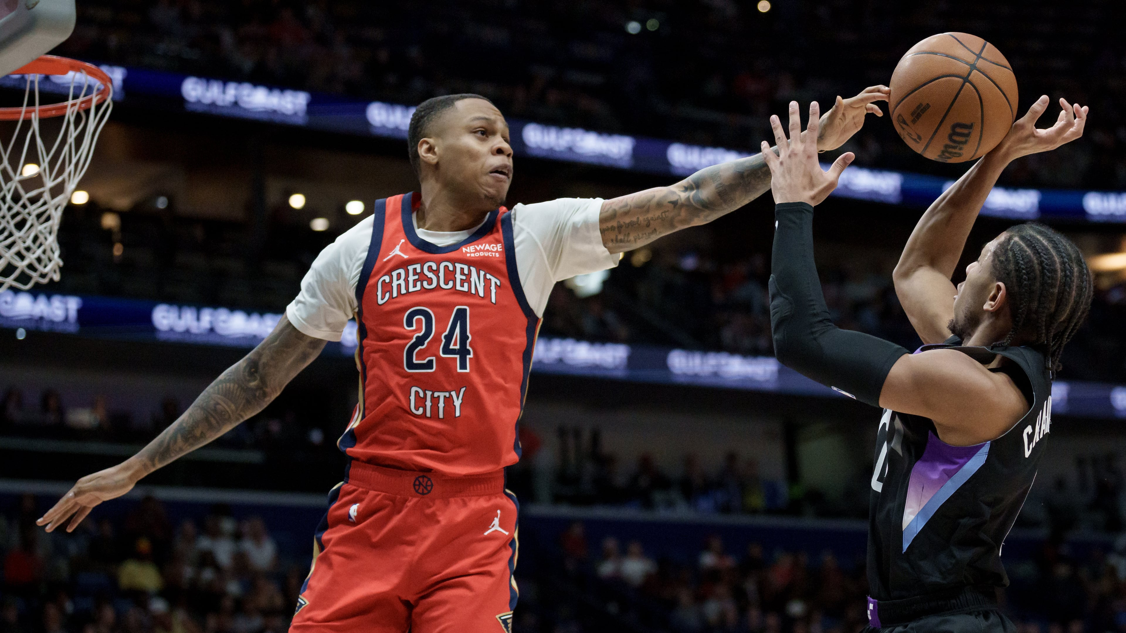 FILE - New Orleans Pelicans guard Jordan Hawkins (24) blocks the shot of Utah Jazz guard Kennedy Chandler (0) during the first half of an NBA basketball game in New Orleans, April 7, 2026. (AP Photo/Matthew Hinton, File)