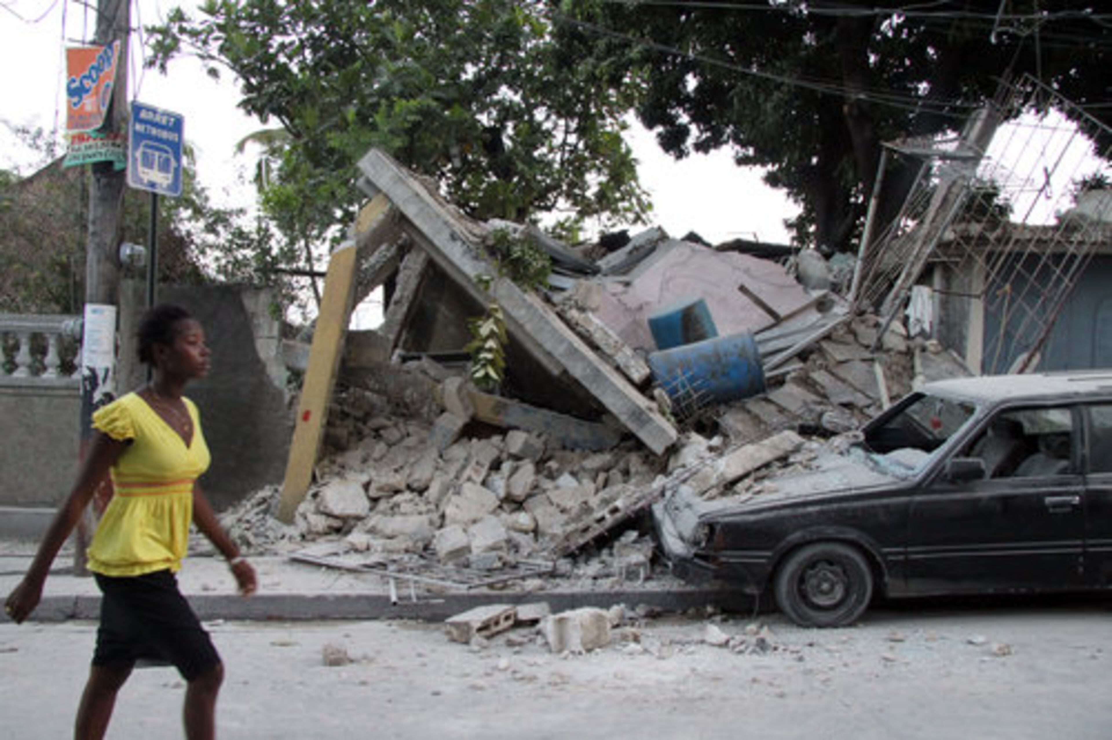 A woman walks past rubble in Port-au-Prince, Haiti, on Wednesday, Jan. 13, 2010. Huge swaths of Port-au-Prince lay in ruins, and thousands of people were feared dead in the rubble of government buildings, foreign aid headquarters and shantytowns that collapsed a day earlier in a powerful earthquake.
