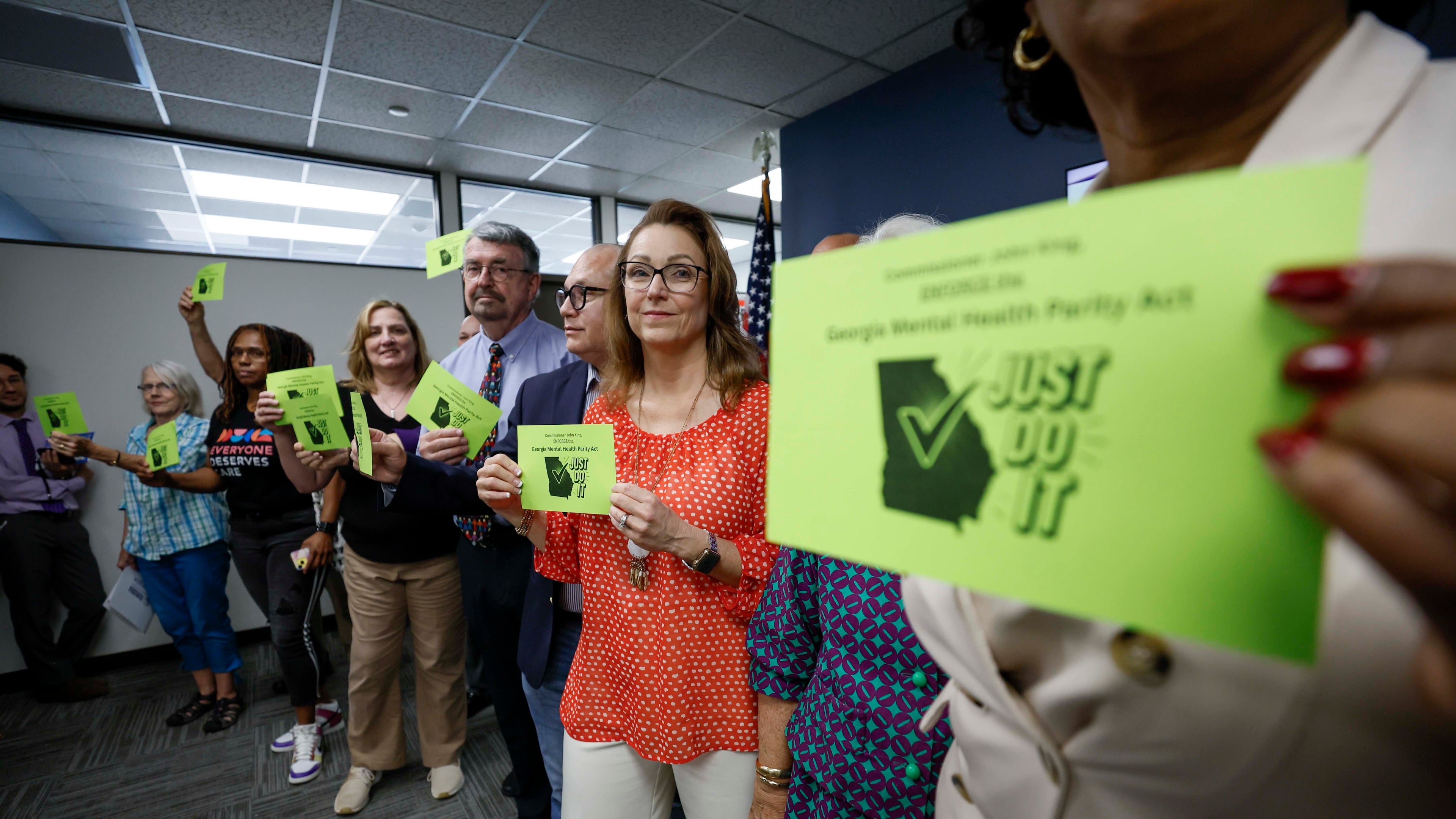 Mental health advocates and leaders gathered in the Sloppy Floyd Capitol Room at the Office of the Commissioner of Insurance and Safety Fire to deliver postcards supporting equal insurance coverage for mental health care last August. (Miguel Martinez/AJC 2025)