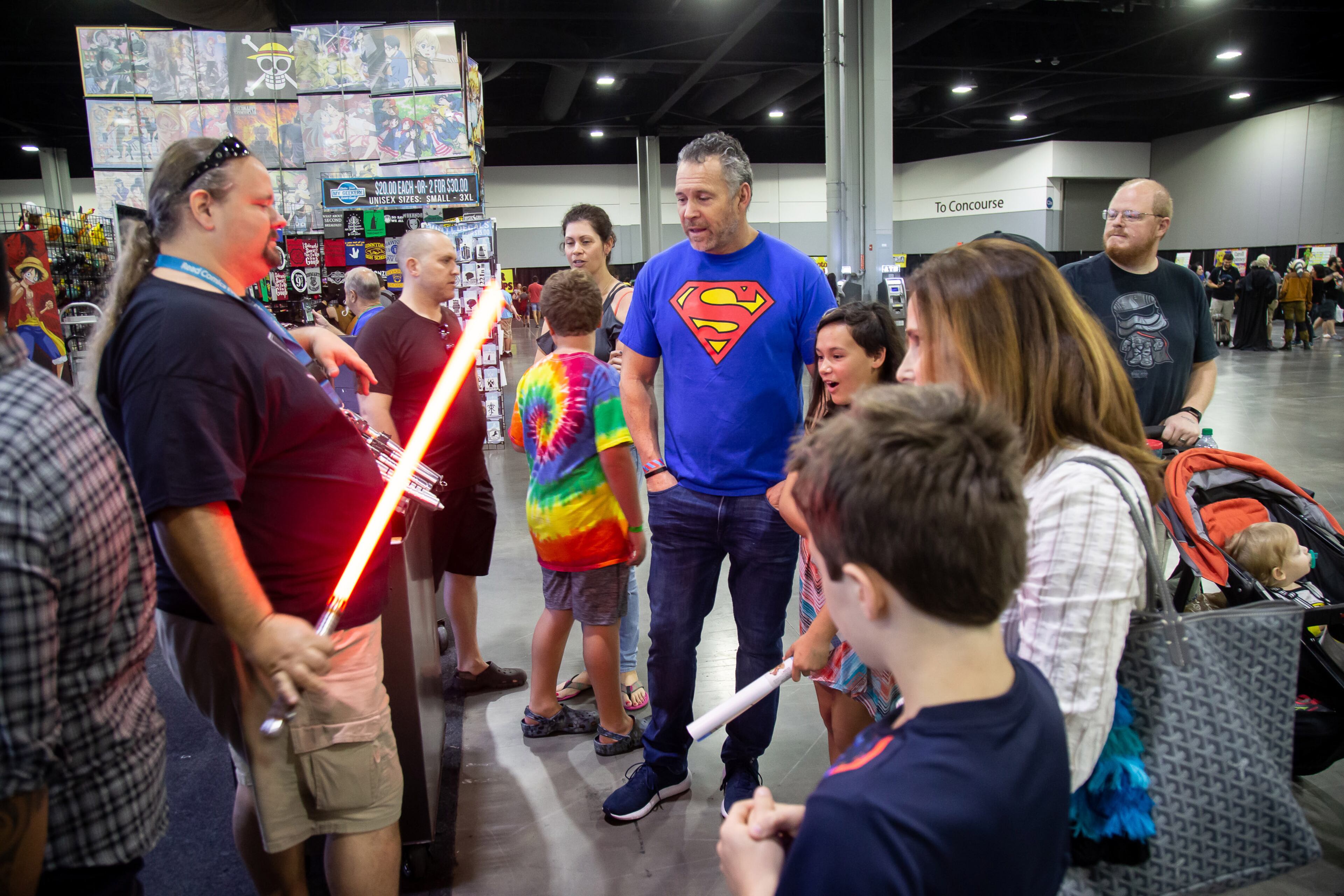 Alan Johnson talks about his lightsaber with customers during the Atlanta Comic Con at the Georgia World Congress Center on Sunday, July 14, 2019. STEVE SCHAEFER / SPECIAL TO THE AJC