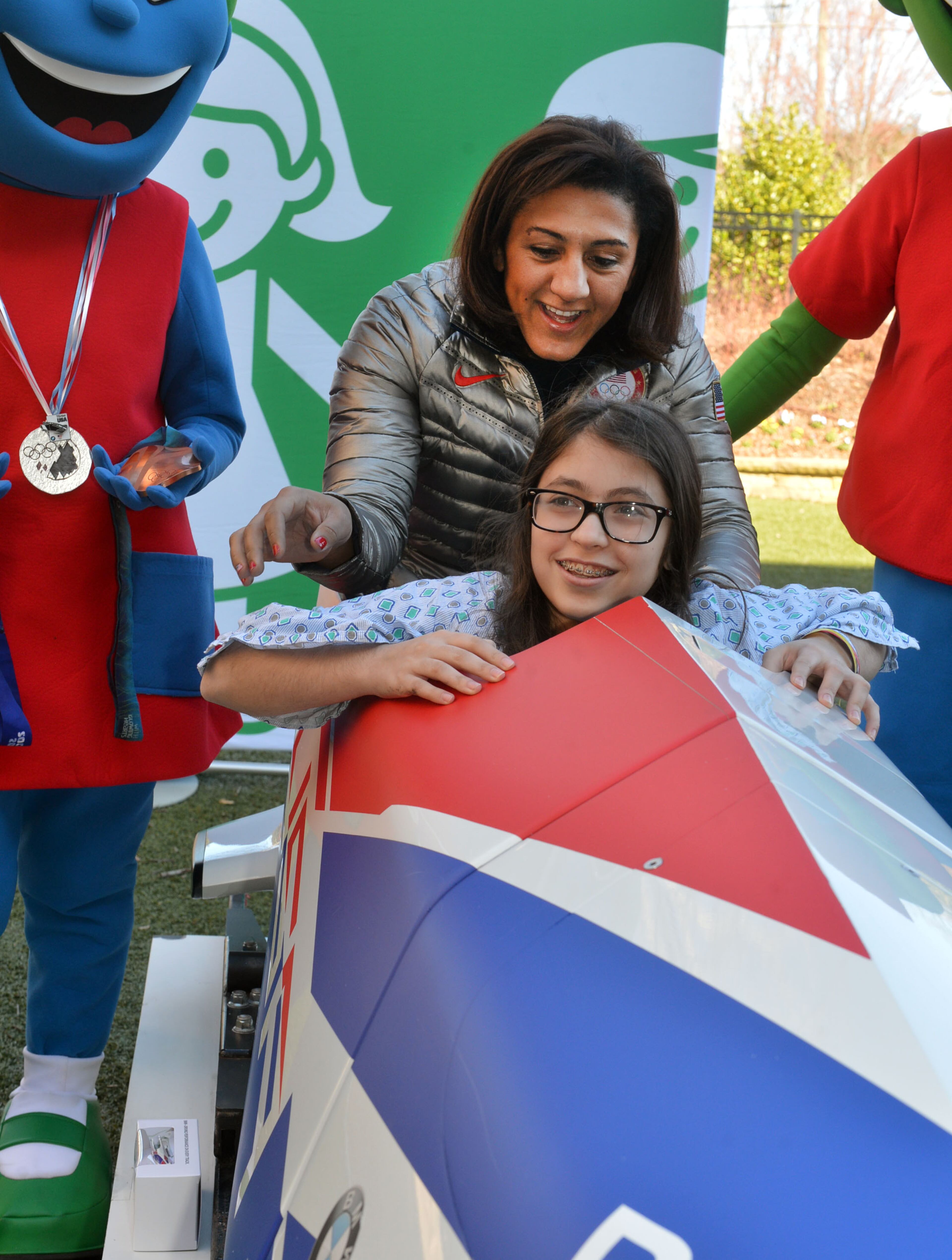 Elana Meyers shows Emerson Shuster, 14, of Johns Creek, how to steer a bobsled during a visit to The Zone at Children's Healthcare of Atlanta at Scottish Rite Monday, Feb. 24, 2014. Meyers finished second in the bobsled competition in Sochi, Russia on Feb. 19, becoming the first U.S. women's bobsledder to win multiple Olympic medals. KENT D. JOHNSON / KDJOHNSON@AJC.COM