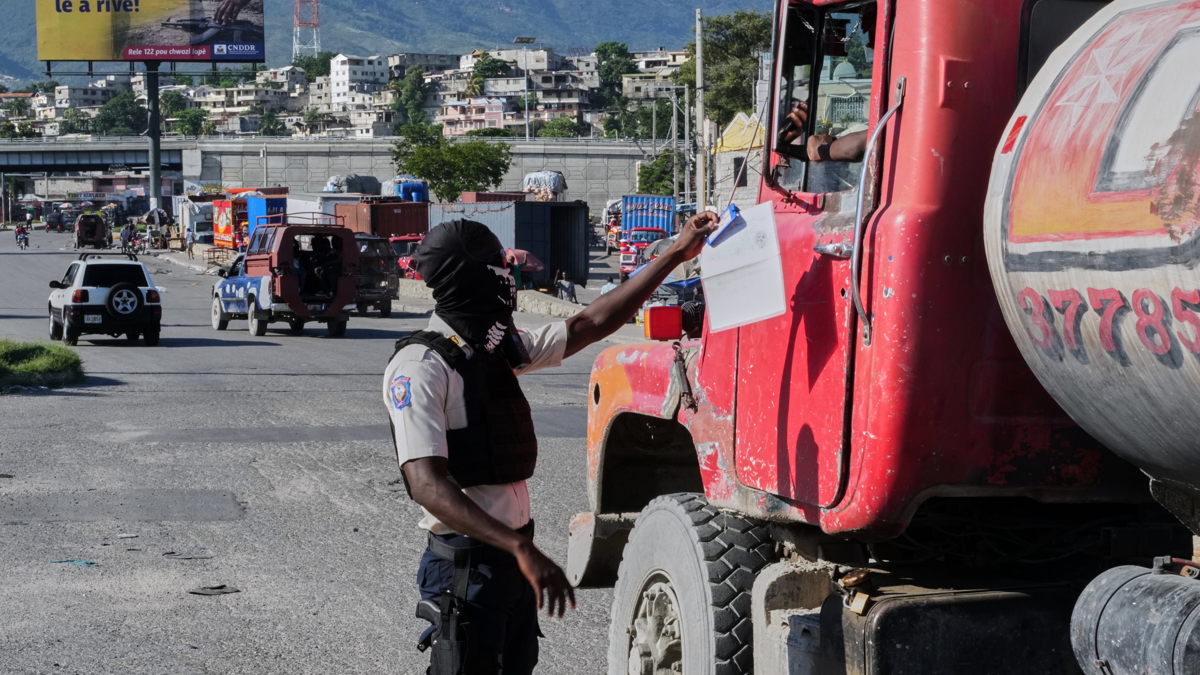 A police officer interacts with a truck driver as he patrols at an intersection in Port-au-Prince, Haiti, Tuesday, Sept. 29, 2026. (AP Photo/Odelyn Joseph)