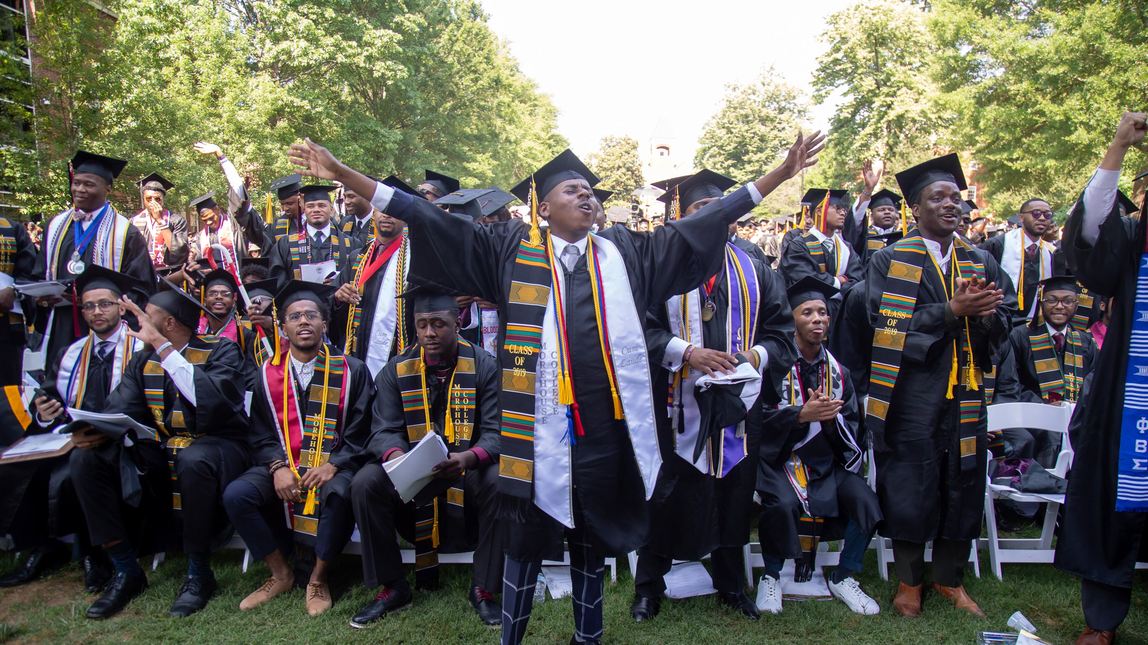 Graduates react after hearing billionaire Robert F. Smith is paying all student debt for the Class of 2019 during the Morehouse College graduation ceremony in Atlanta on Sunday, May 19, 2019. STEVE SCHAEFER / SPECIAL TO THE AJC