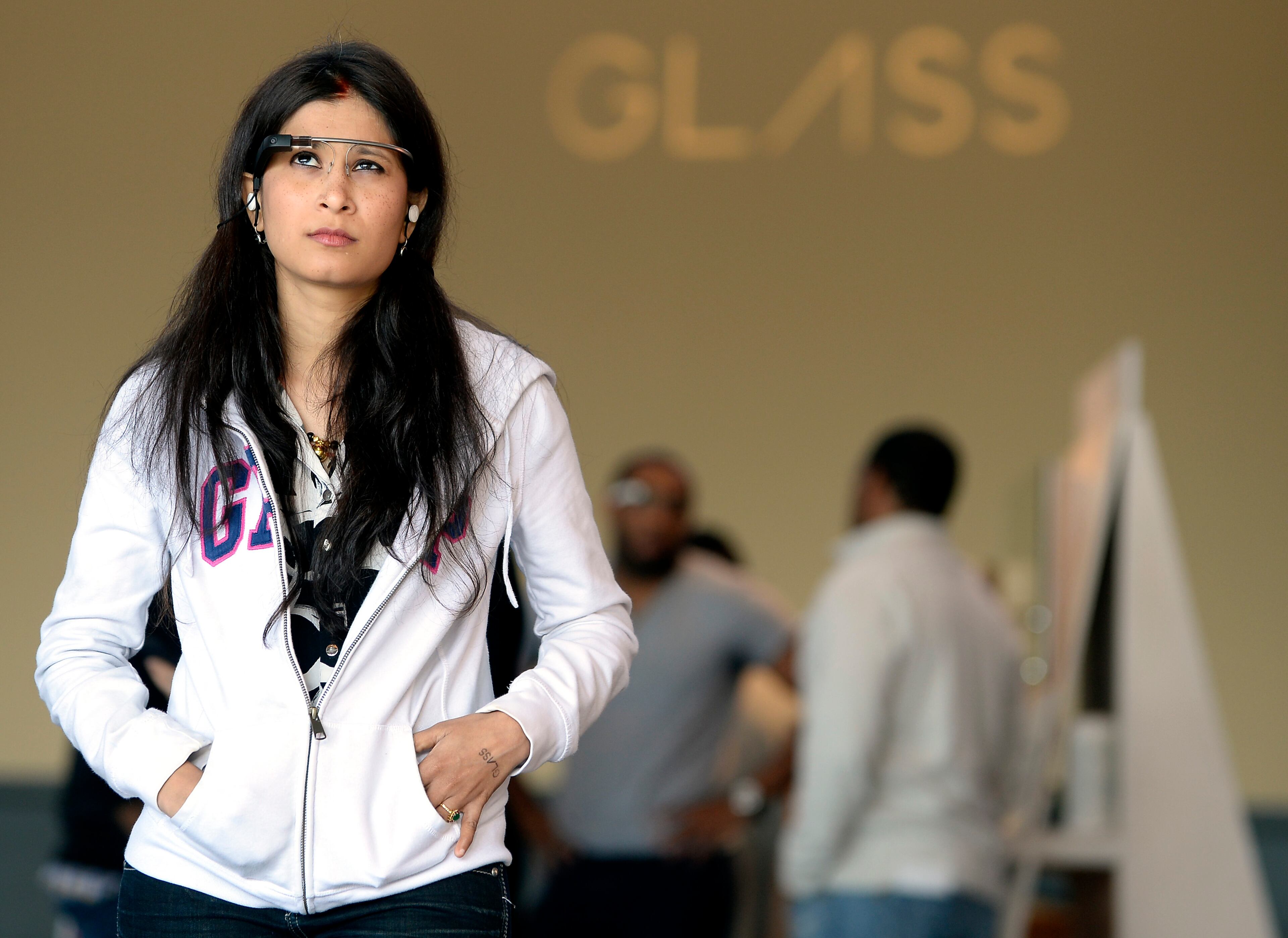 Ambika Soorappaiah, of India, views the tiny Google Glass screen as it projects an image that appears to hover about 10 feet away from users' eyes during a hands-on demonstration at Puritan Mill Saturday, Feb. 8, 2014, in Atlanta. "I'm really loving it," said Soorappaiah, "It's really very attractive and it's easy to use." David Tulis / AJC Special