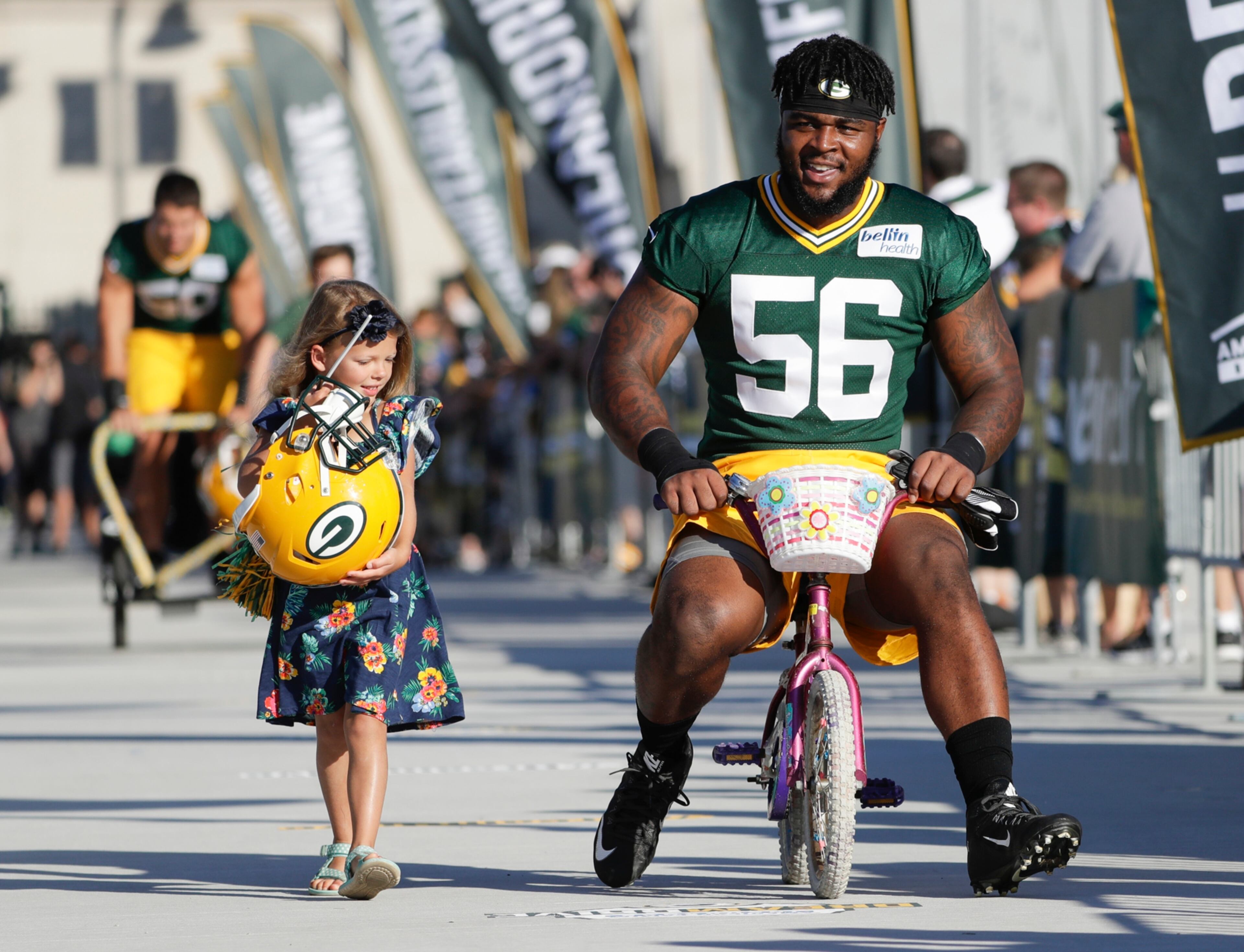 Green Bay Packers' Johnathan Calvin rides a bike to NFL football training camp Thursday, July 27, 2017, in Green Bay, Wis. (AP Photo/Morry Gash)