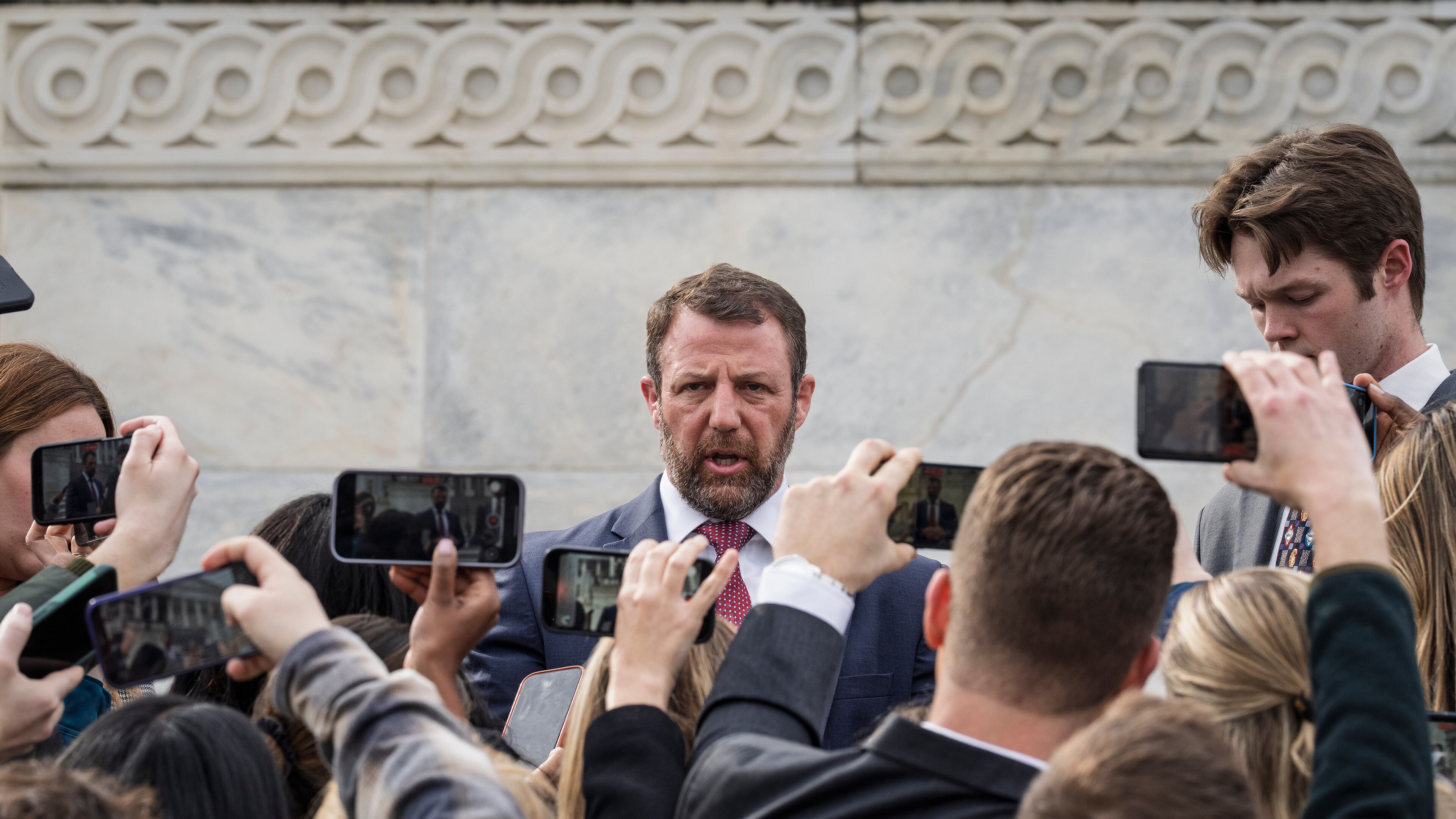 Sen. Markwayne Mullin, R-Okla., speaks with reporters on the steps at the Capitol in Washington, Thursday, March 5, 2026. (AP Photo/J. Scott Applewhite)