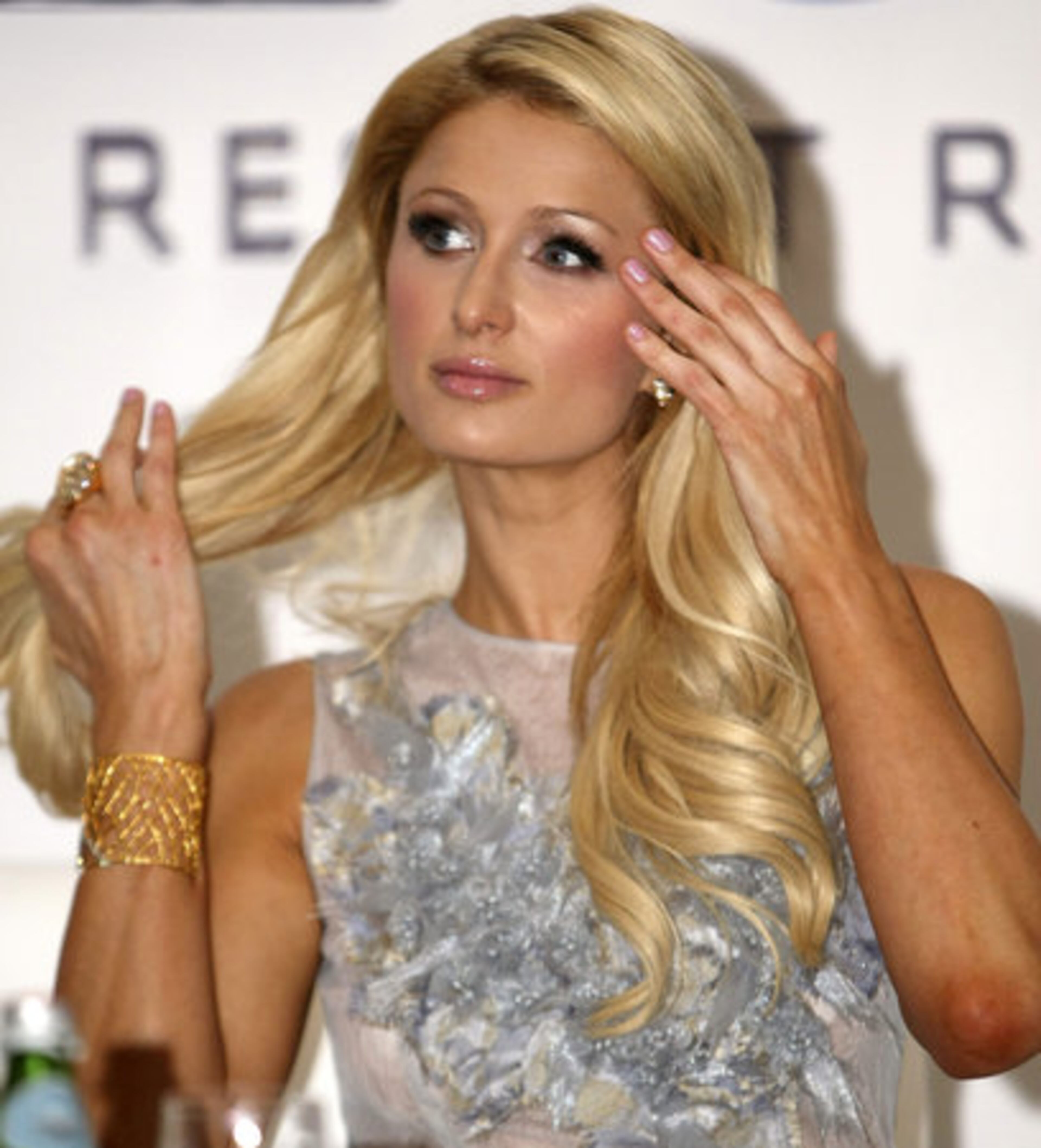 Hilton finds time to play with her hair during a news conference at the financial district of Makati city, east of Manila, Philippines.