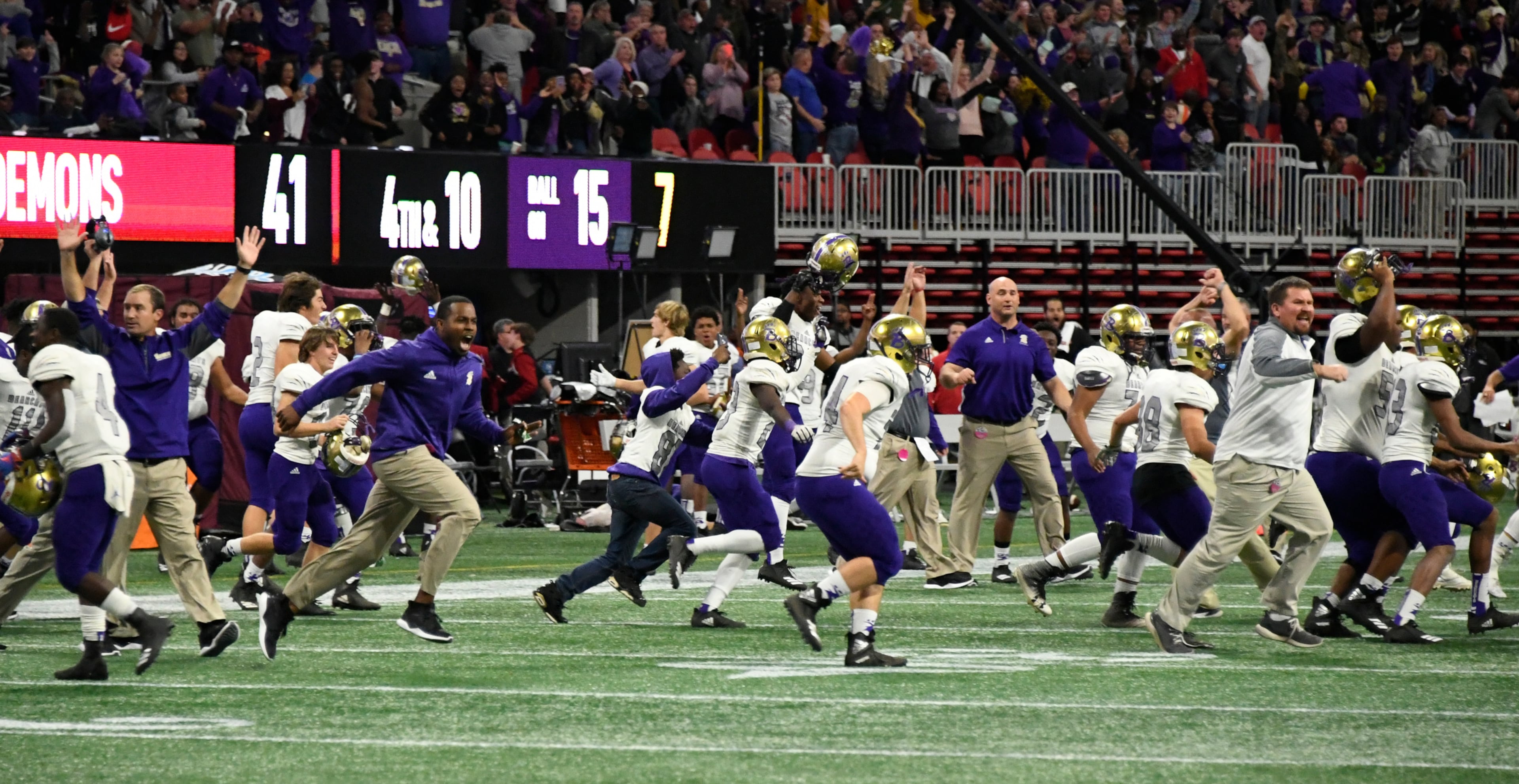 Bainbridge players and coaches celebrate after Warner Robins is unable to score in the third overtime, thus winning their class 5A high school championship football game, Tuesday, Dec., 11, 2018, at Mercedes-Benz Stadium, in Atlanta. Bainbridge won in 3 overtimes 47-41.