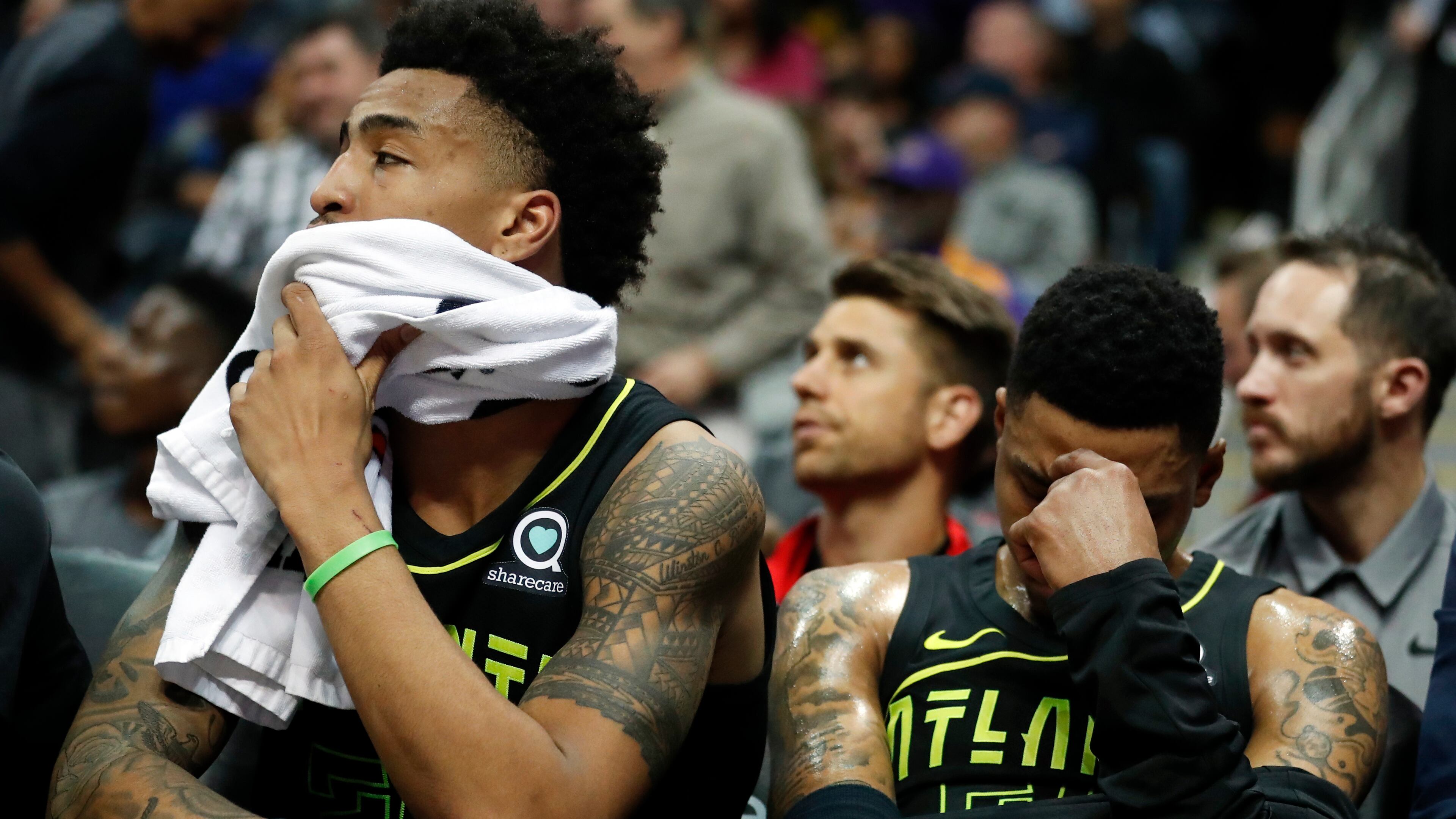 Atlanta Hawks guard Kent Bazemore (right), and John Collins sit on the bench in the finals minutes in loss against the Los Angeles Lakers Monday, Feb. 26, 2018, in Atlanta.