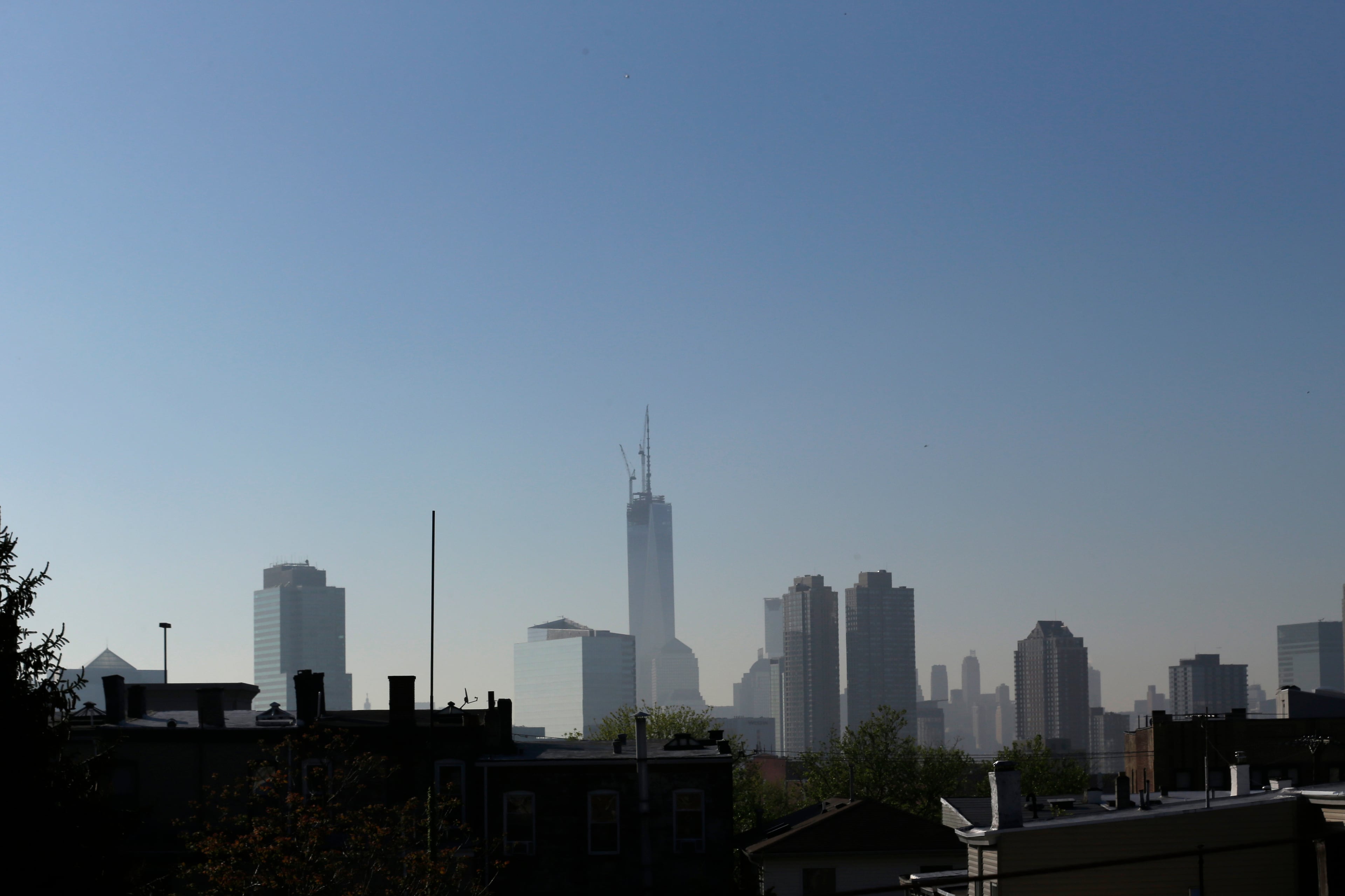 One World Trade Center, top center, seen from the Heights neighborhood of Jersey City, N.J., Friday, May 10, 2013, after 408-foot spire was set into place at the top of the structure. With the spire, the building rises at a symbolic 1,776 feet tall. (AP Photo/Julio Cortez)