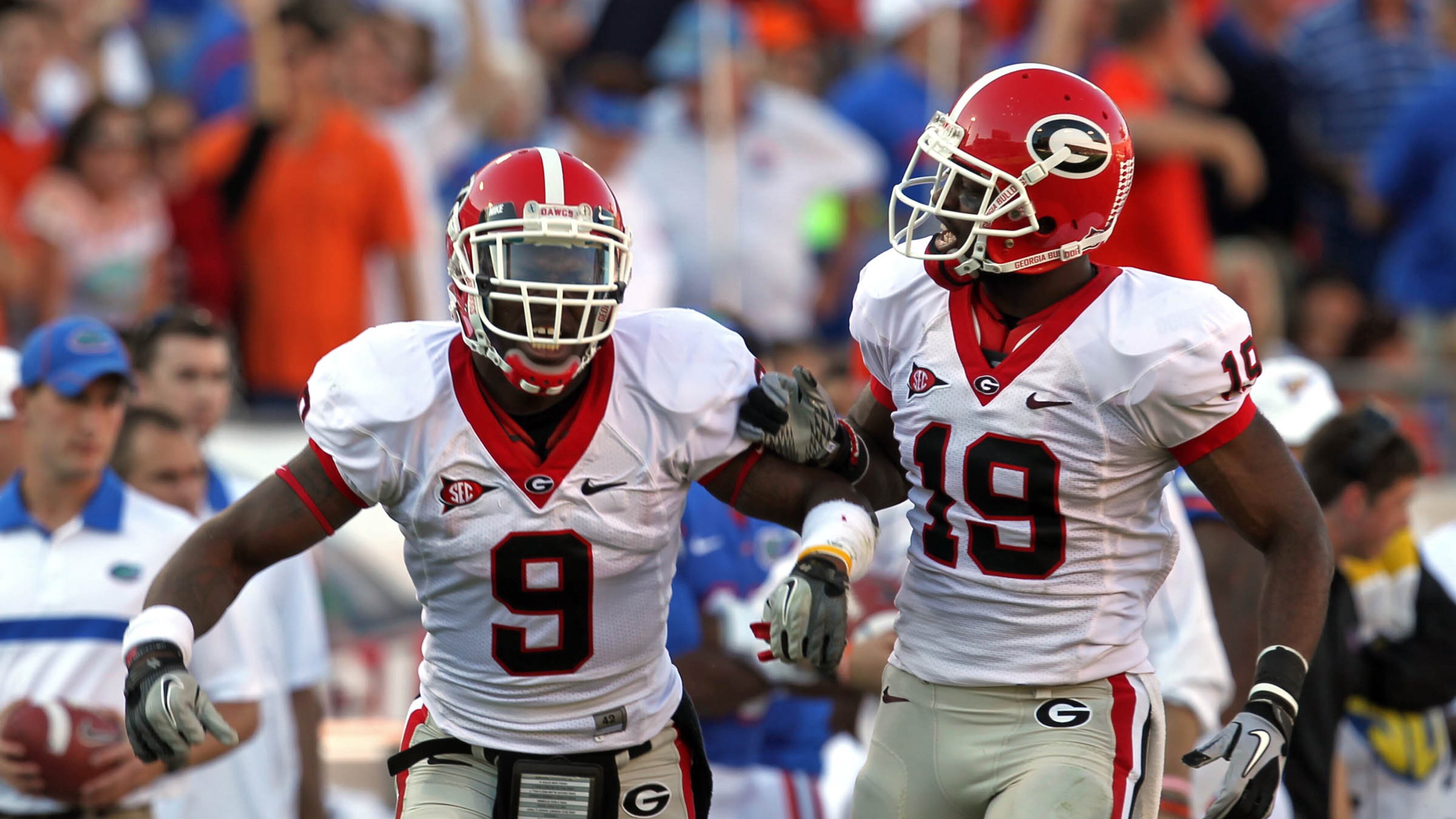 Georgia linebacker Alec Ogletree (9) and cornerback Sanders Commings (19) celebrate a Florida fumble and Georgia recovery in the first half of a 24-20 win over Florida in 2011. Commings has decided to pursue a baseball career and signed a minor-league contract with the Braves this week. (Jason Getz jgetz@ajc.com)
