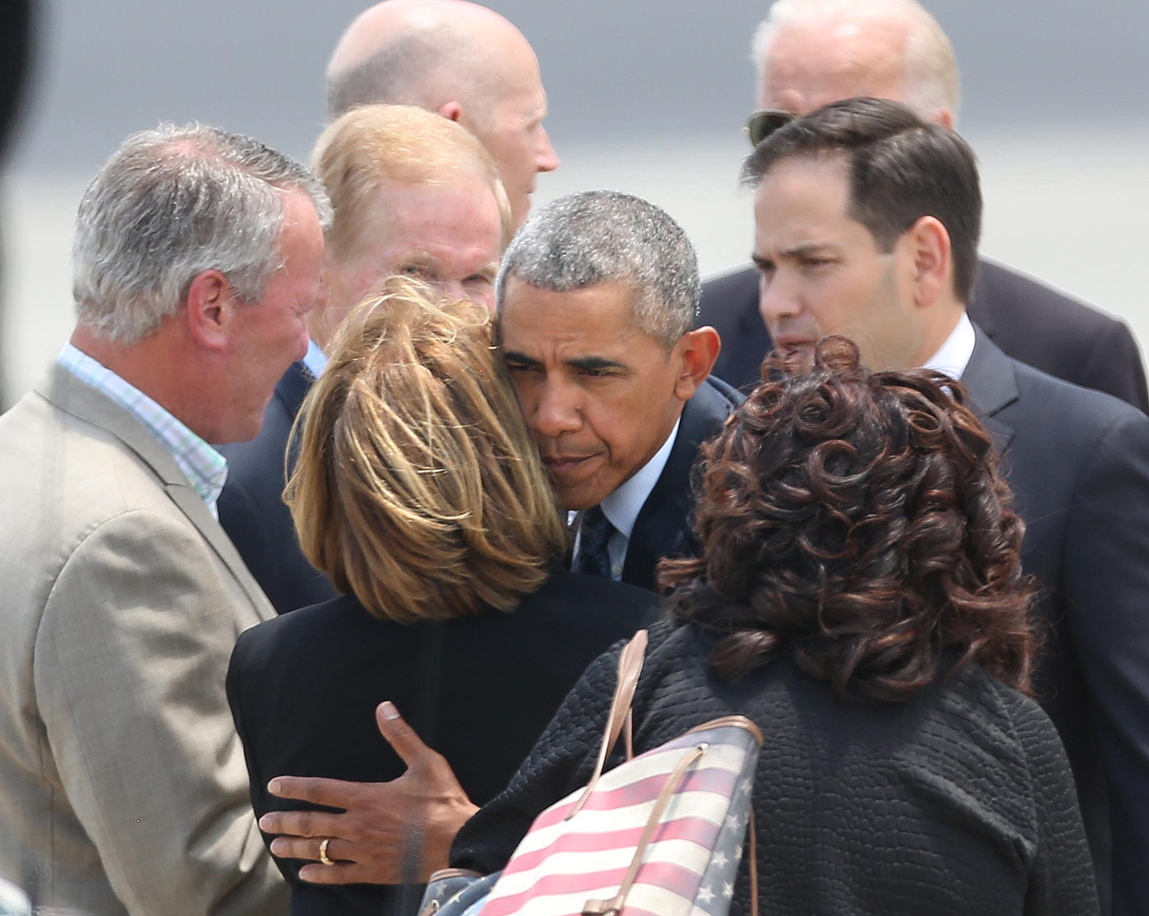 President Barack Obama hugs Orange County Mayor Teresa Jacobs upon the president's arrival at Orlando International Airport, Thursday, June 16, 2016, in Orlando, Fla. Obama is in Orlando today to pay respects to the victims of the Pulse nightclub shooting and meet with families of victims of the attack. (Stephen M. Dowell/Orlando Sentinel via AP)