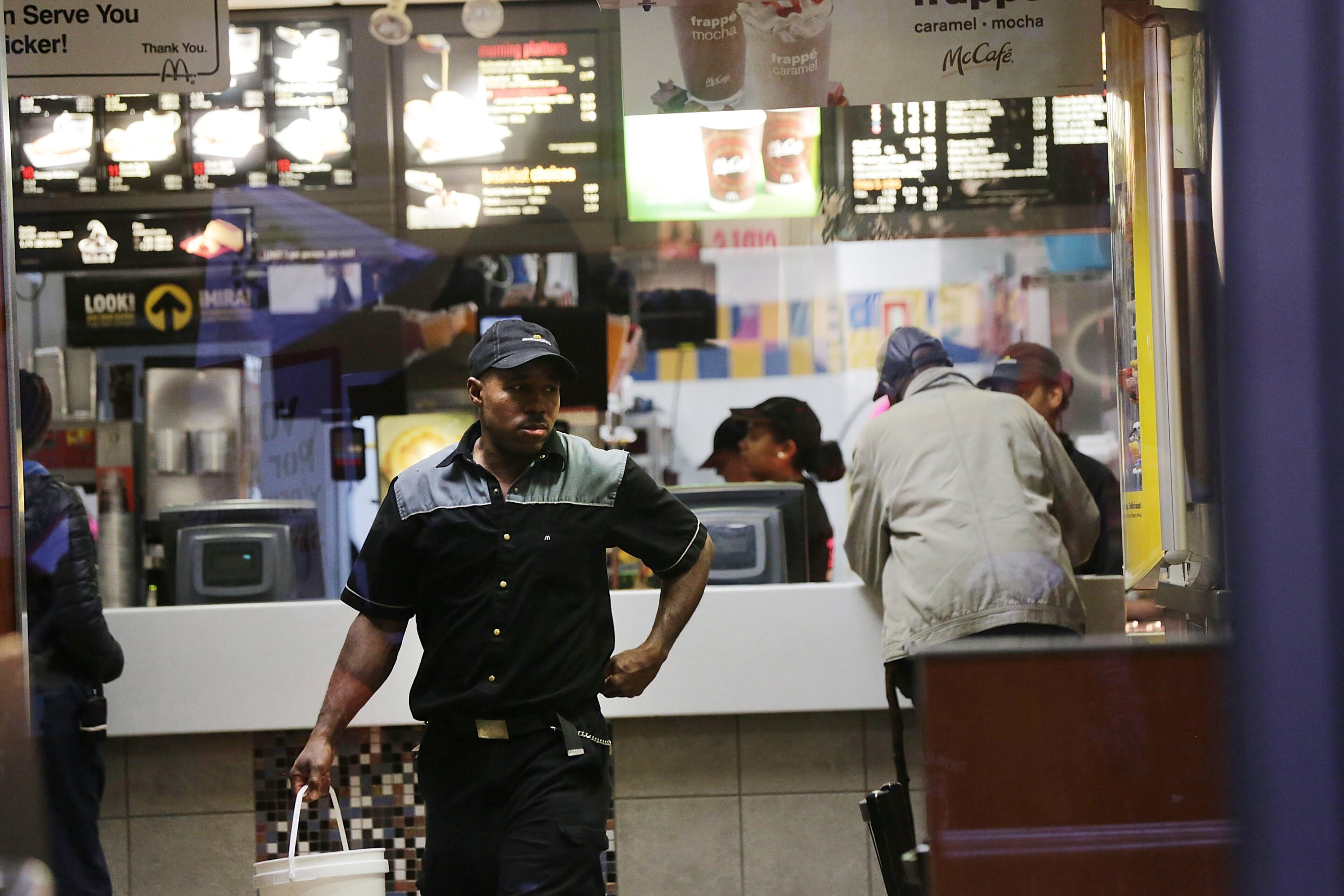 NEW YORK, NY - NOVEMBER 10: A McDonalds worker walks in a restaurant on November 10, 2015 in New York, United States. In what organizers are calling a National Day of Action for $15 and hour minimum wage, thousands of people took to the streets across the country to stage protests in front of businesses that are paying some of their workers the minimum wage. Home care workers, employees in retail and fast food restaurants say that the current minimum is not a living wage. (Photo by Spencer Platt/Getty Images)